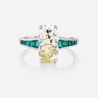 A fancy yellow diamond, diamond, emerald, and platinum ring