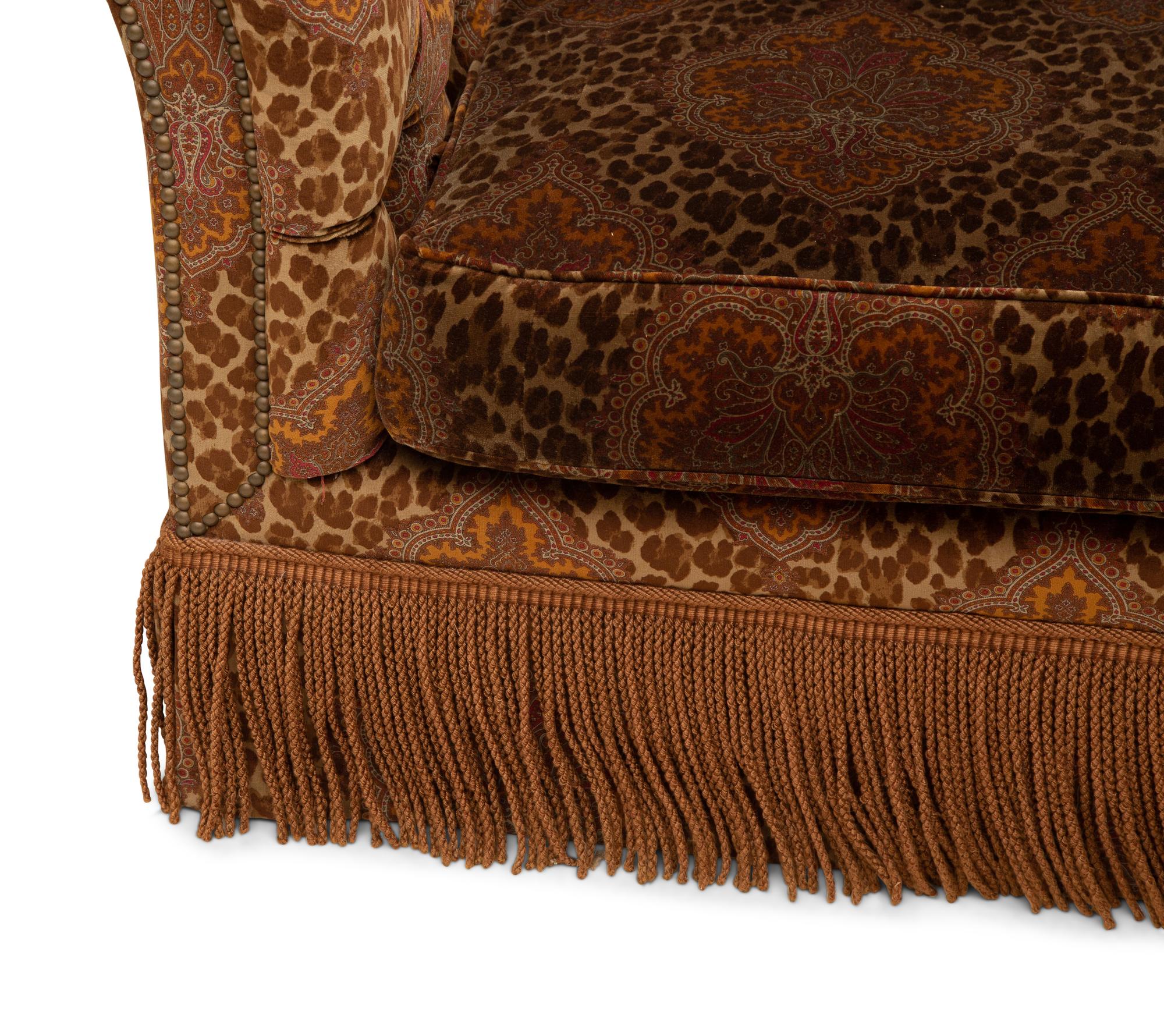 A Chesterfield Style Velvet-Upholstered Sofa with a Fringed Skirt