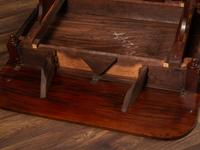 A Classical Parcel Gilt and Ebonized, Figured Mahogany Paw-Foot Drop-Leaf Table