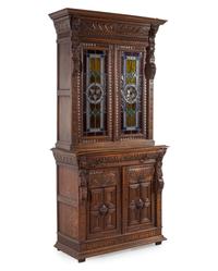A Renaissance Revival Carved Oak and Leaded Glass Bookcase