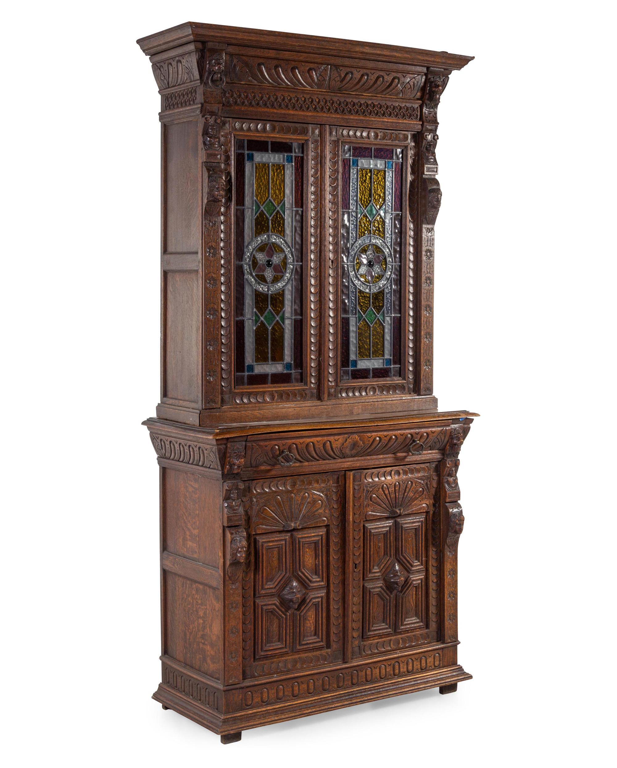 A Renaissance Revival Carved Oak and Leaded Glass Bookcase