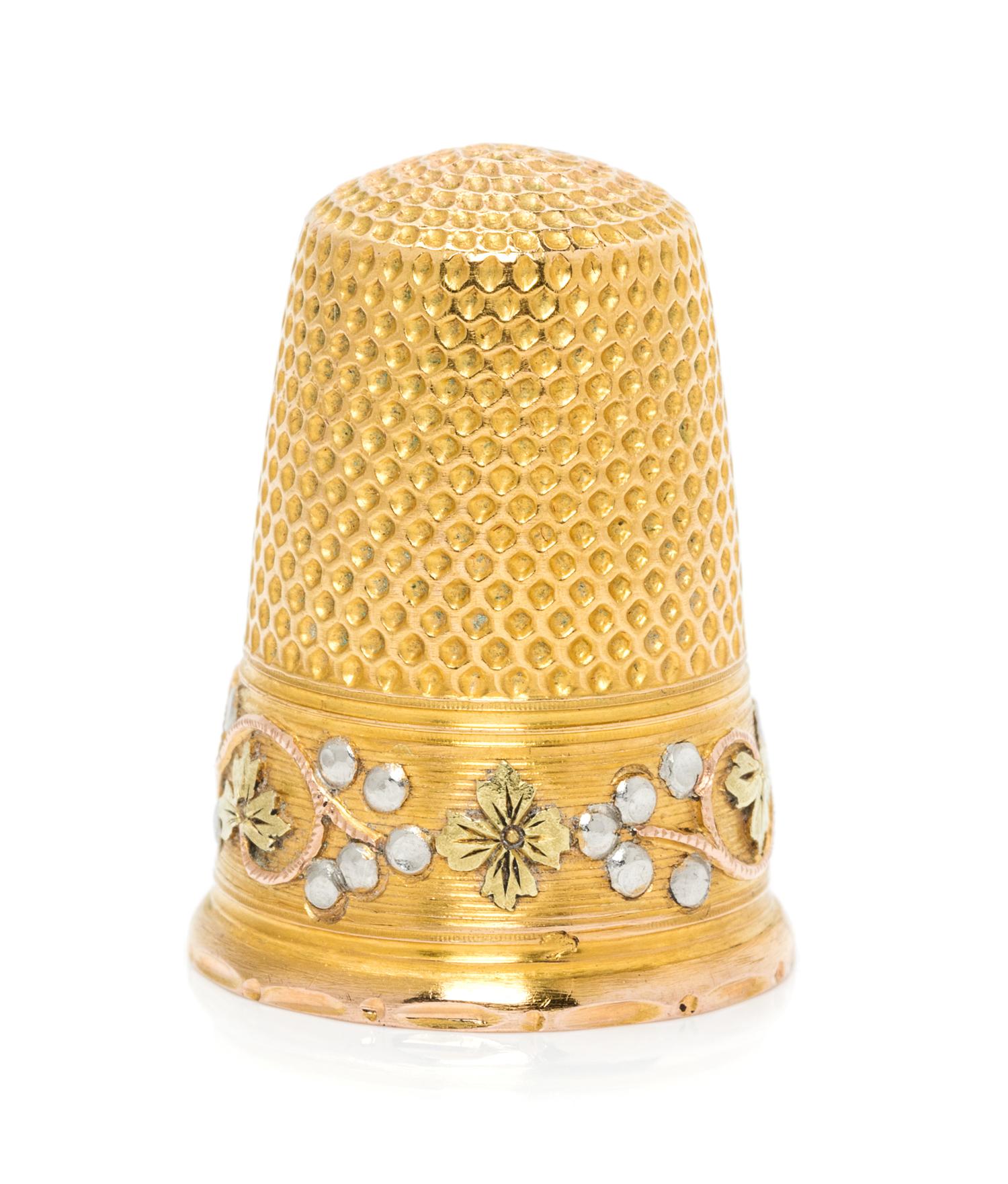 A French Tri-Colored Gold Thimble, , the knurled top and body above a rose, white and yellow gold band worked to show foliate and berry