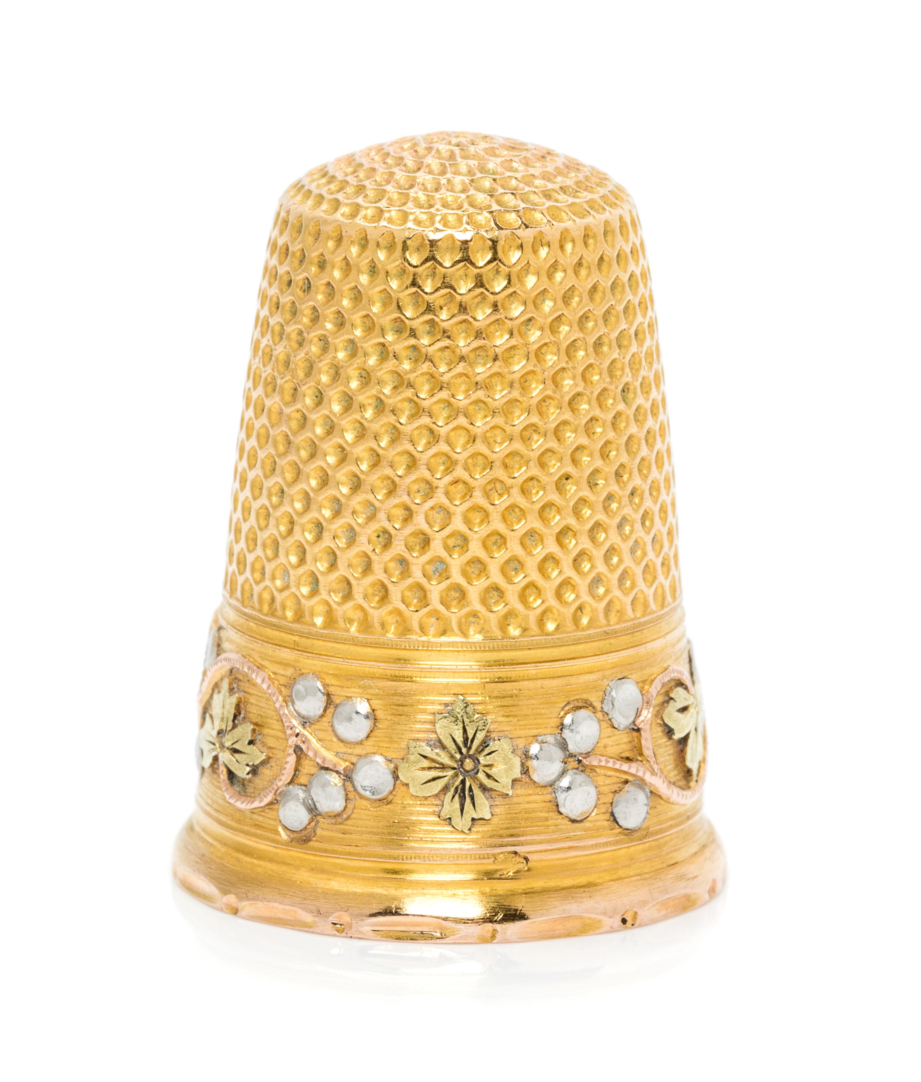 A French Tri-Colored Gold Thimble, , the knurled top and body above a rose, white and yellow gold band worked to show foliate and berry