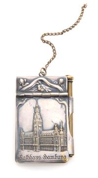 A Continental Silver Chatelaine Notepad, , the case worked to show flowering branches and opening to a partial sheet of stamp-cut paper