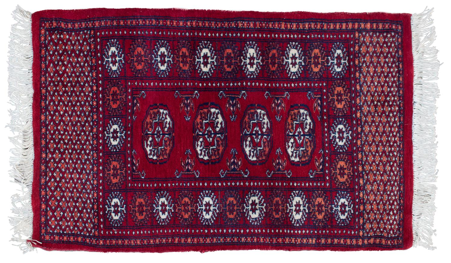A Bokhara Wool Rug 3 feet 1 inch by 2 feet.