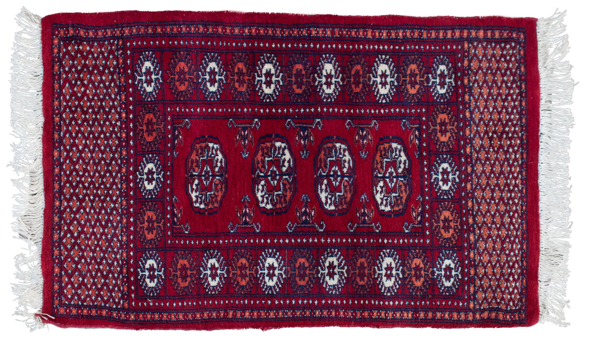 A Bokhara Wool Rug 3 feet 1 inch by 2 feet.