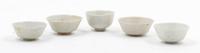 A Set of Five White Glazed Porcelain Cups Diameter of largest 3 inches.