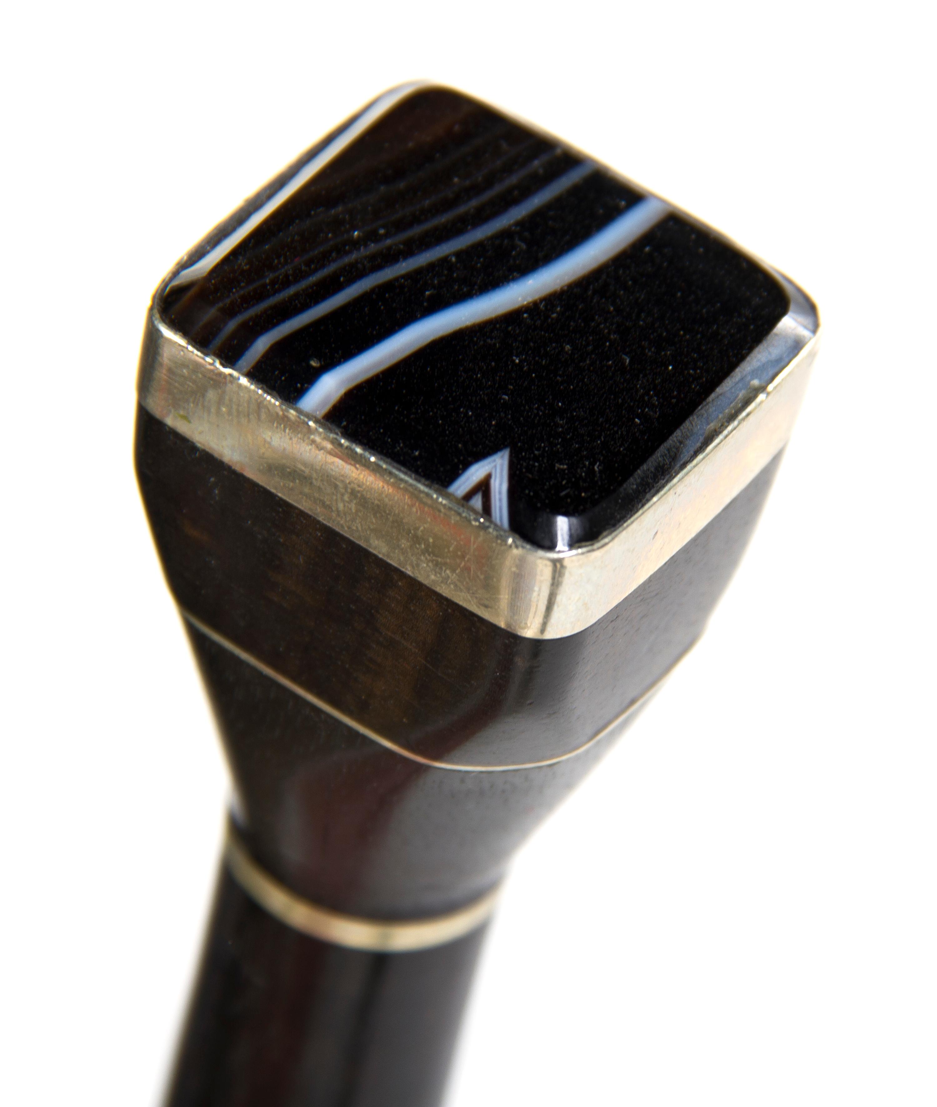 A Polished Agate Mounted and Ebony Walking Stick, Height overall 35 3/4 x width of handle 1 1/4 inches.