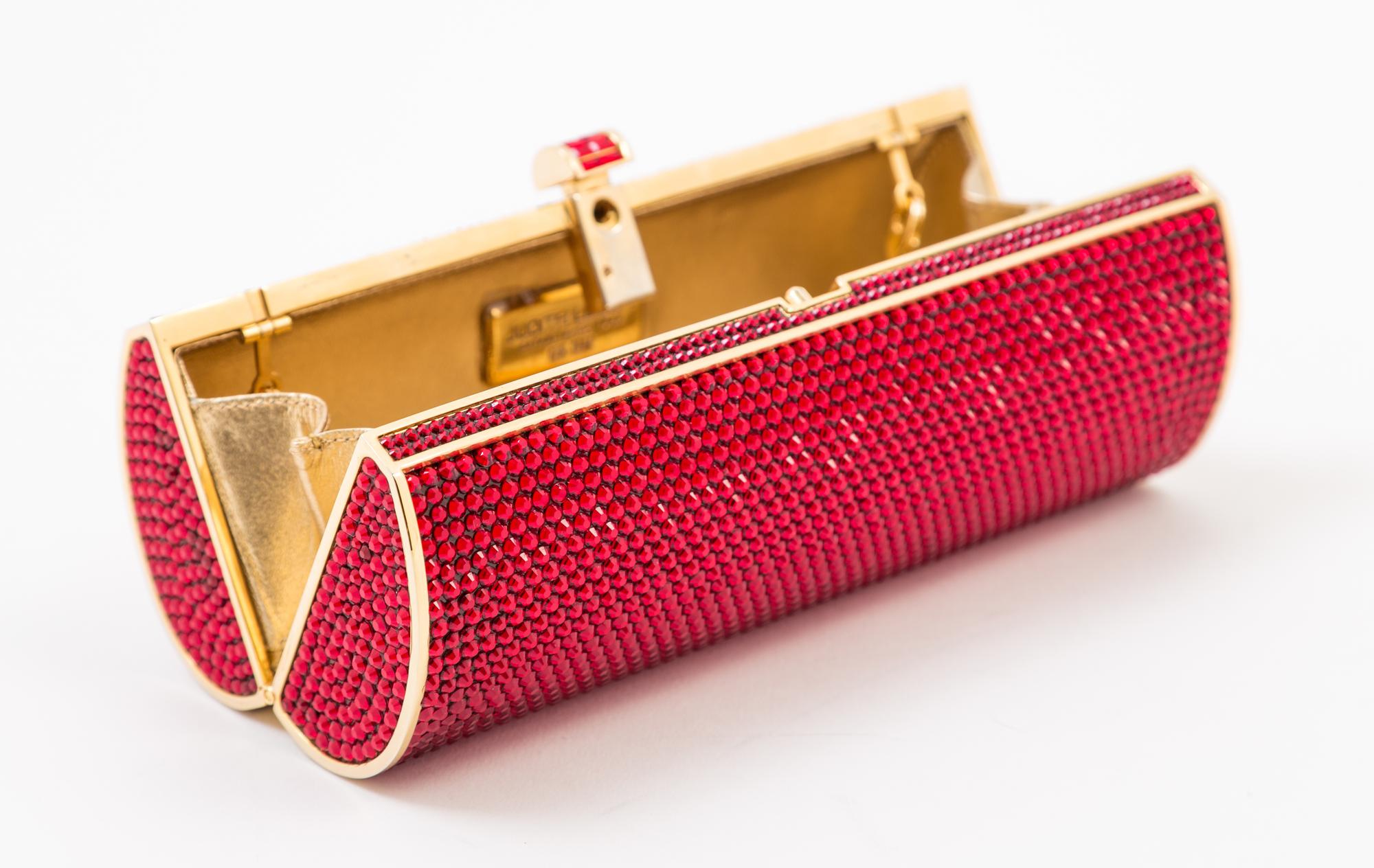 A Judith Leiber Ruby Red Crystal Oblong Clutch, 6.5" x 3" x 2".