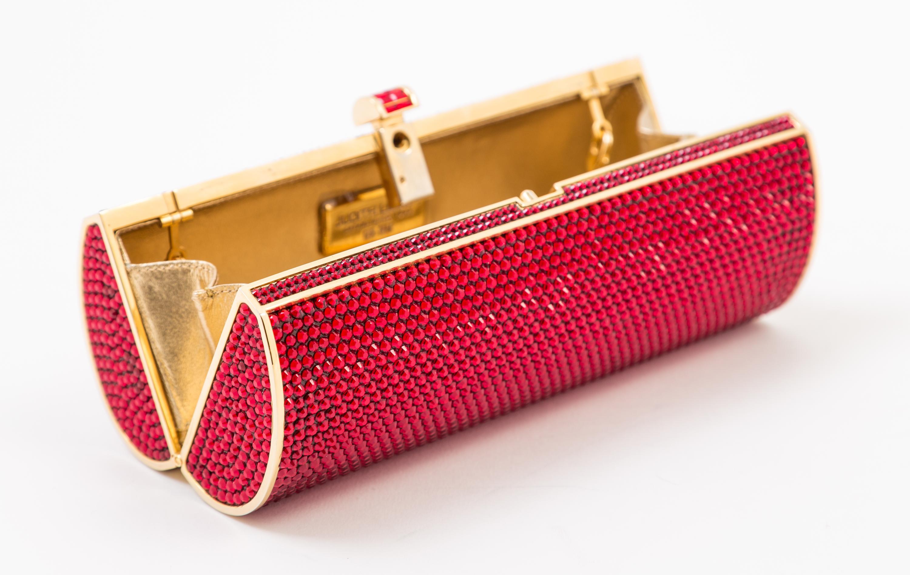 A Judith Leiber Ruby Red Crystal Oblong Clutch, 6.5" x 3" x 2".