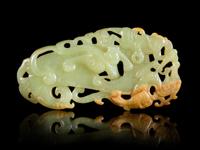 A Reticulated Celadon and Russet Jade Plaque Length 3 5/8 inches.