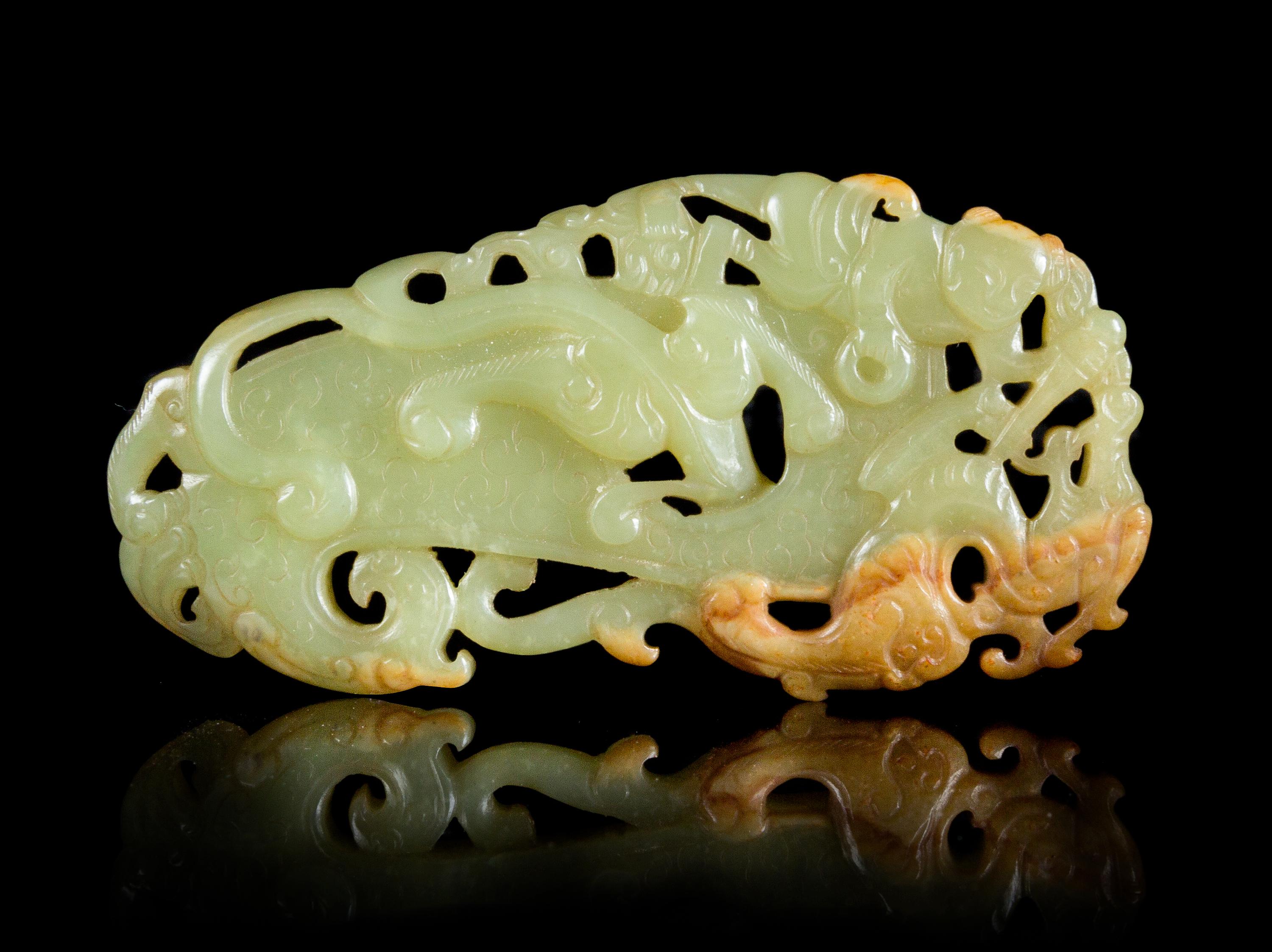A Reticulated Celadon and Russet Jade Plaque Length 3 5/8 inches.