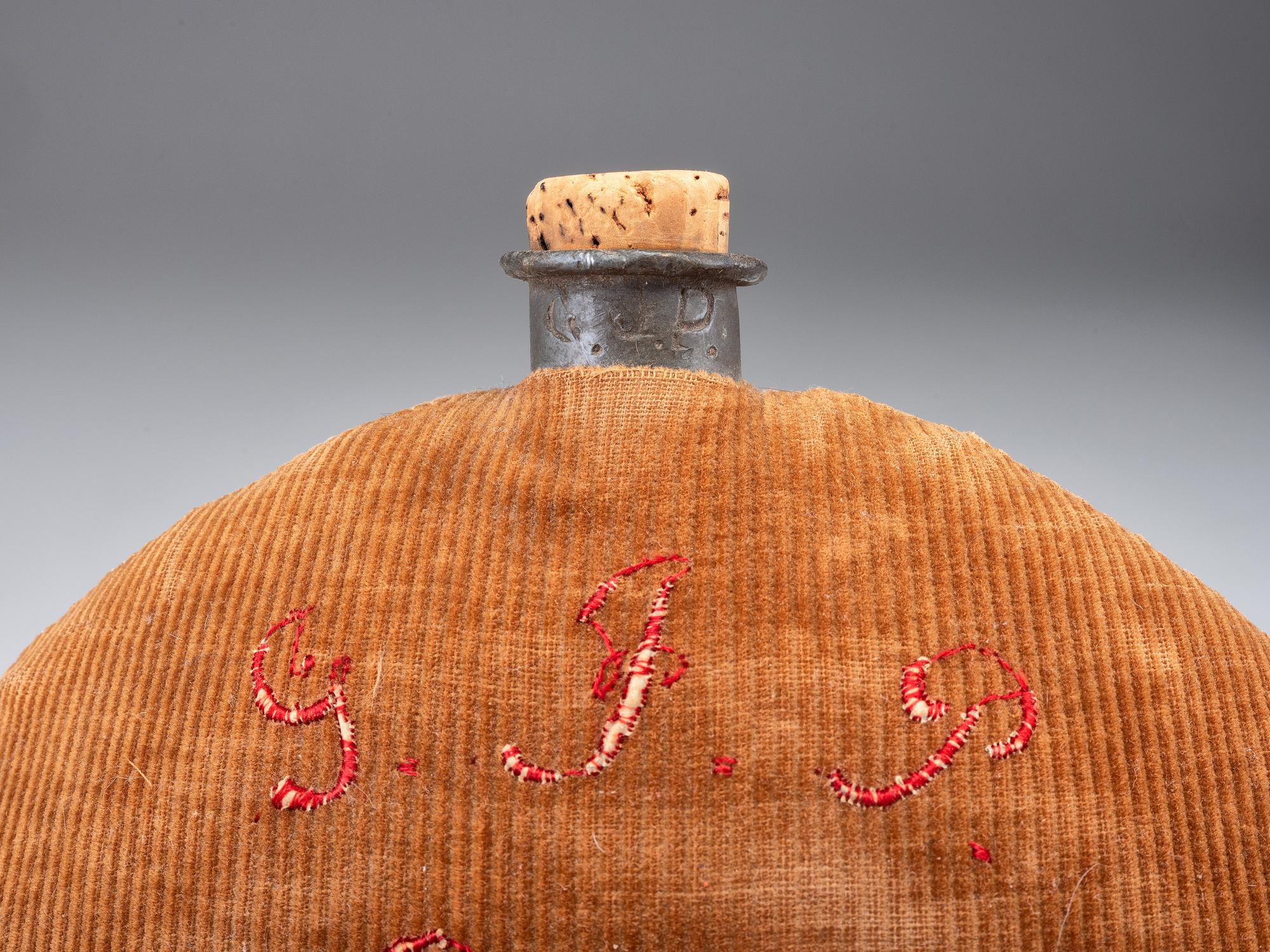 [CIVIL WAR]. A group of 3 items identified to George J. Putney, Company E, 29th Ohio Infantry, comprised of a silver corps badge engraved with battle honors, embellished canteen, and book taken from wreckage at Bristoe Station.