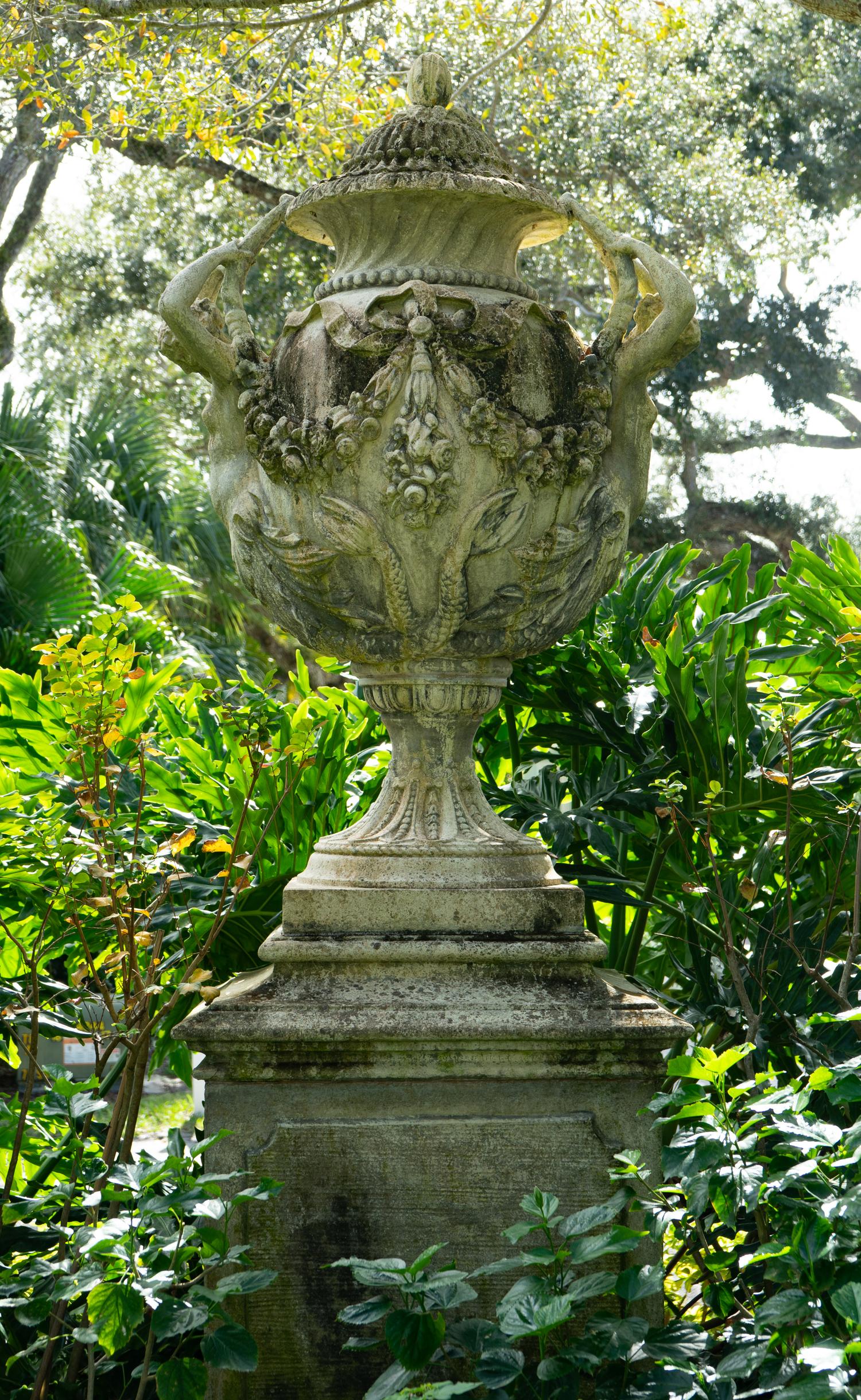 An English Monumental Carved Stone Urn on a Pedestal Base
