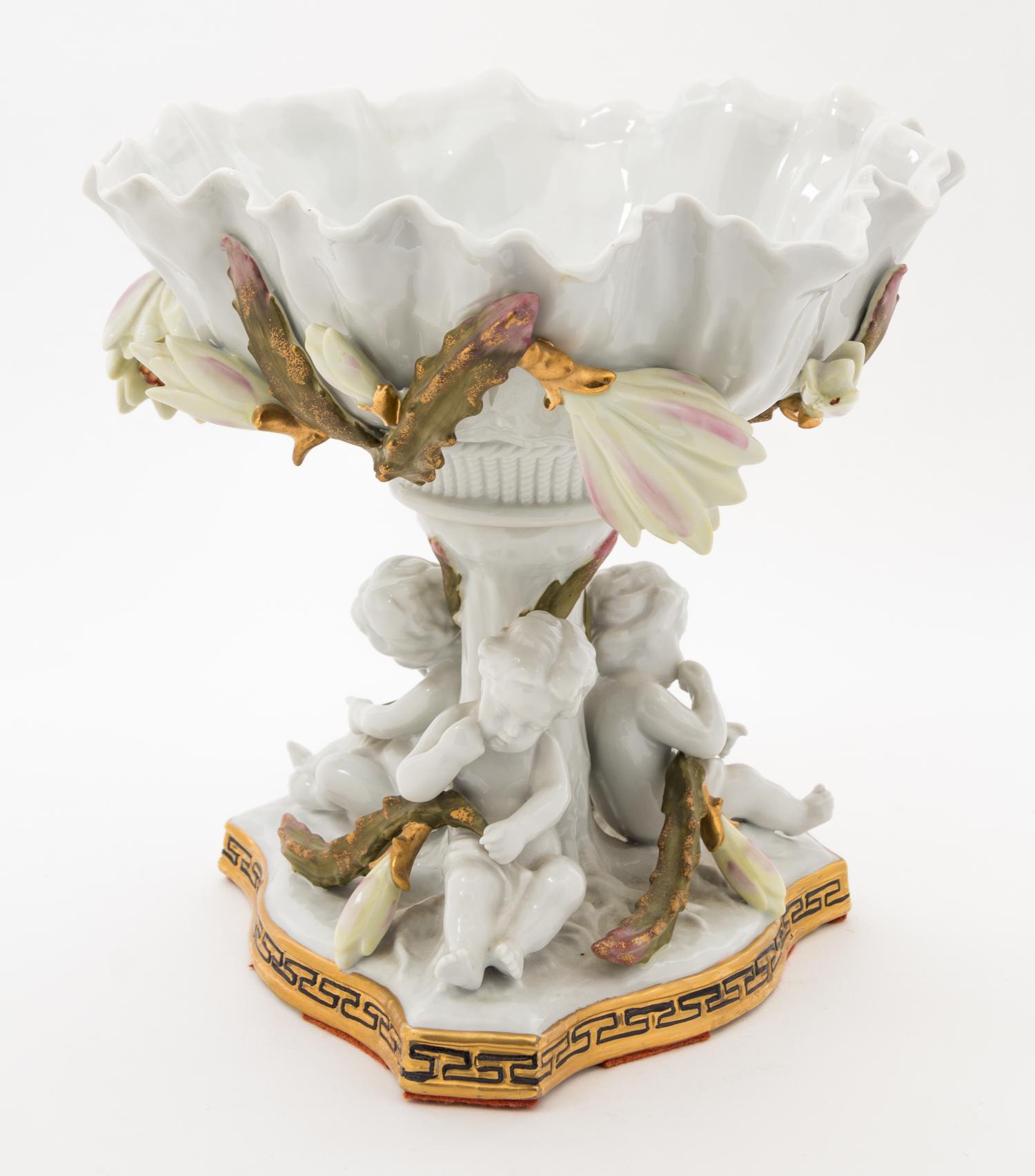 A Continental Figural Porcelain Compote Height 9 1/2 inches.