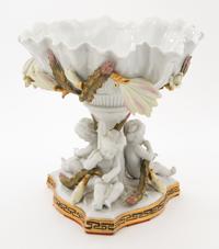 A Continental Figural Porcelain Compote Height 9 1/2 inches.