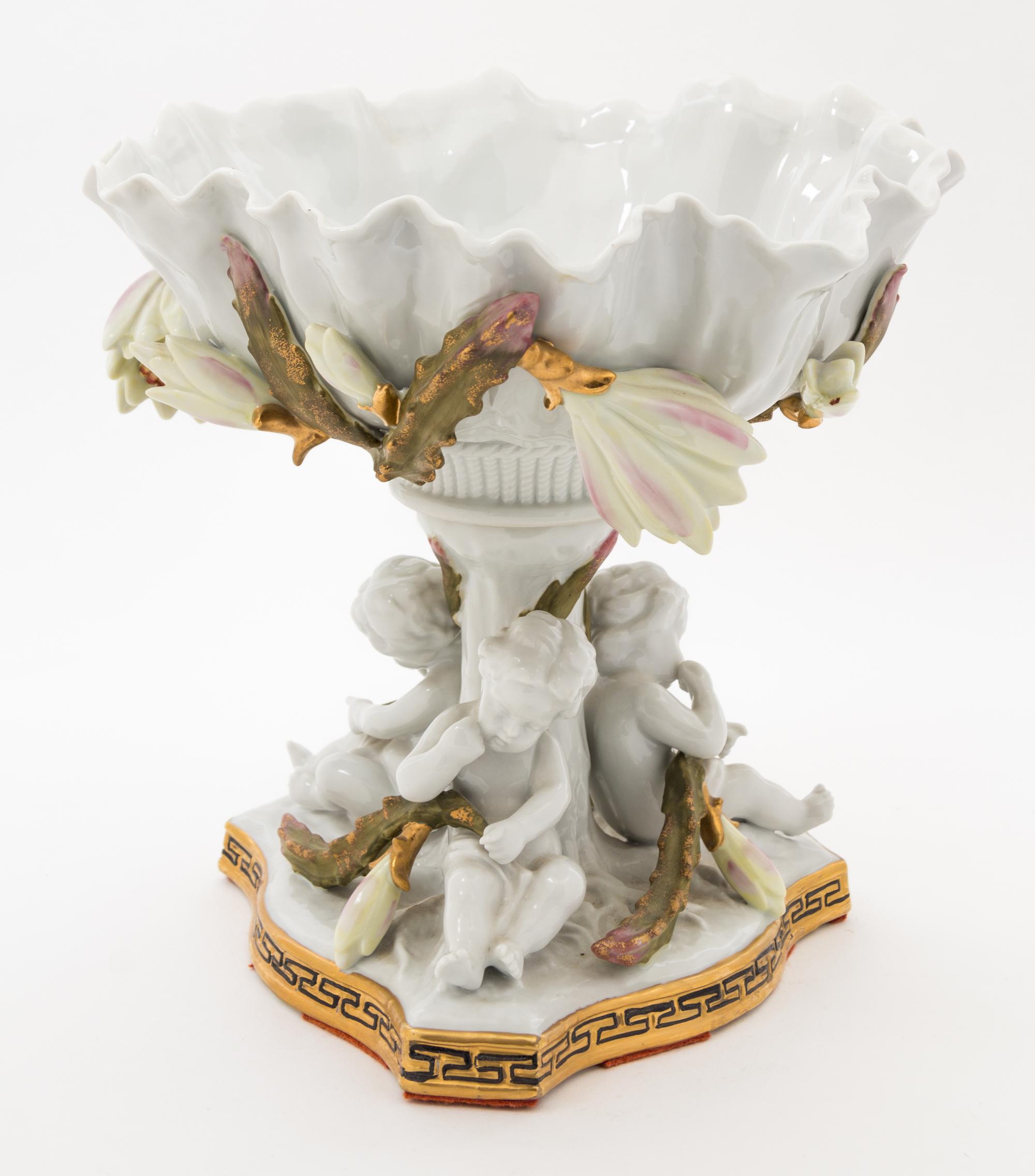 A Continental Figural Porcelain Compote Height 9 1/2 inches.
