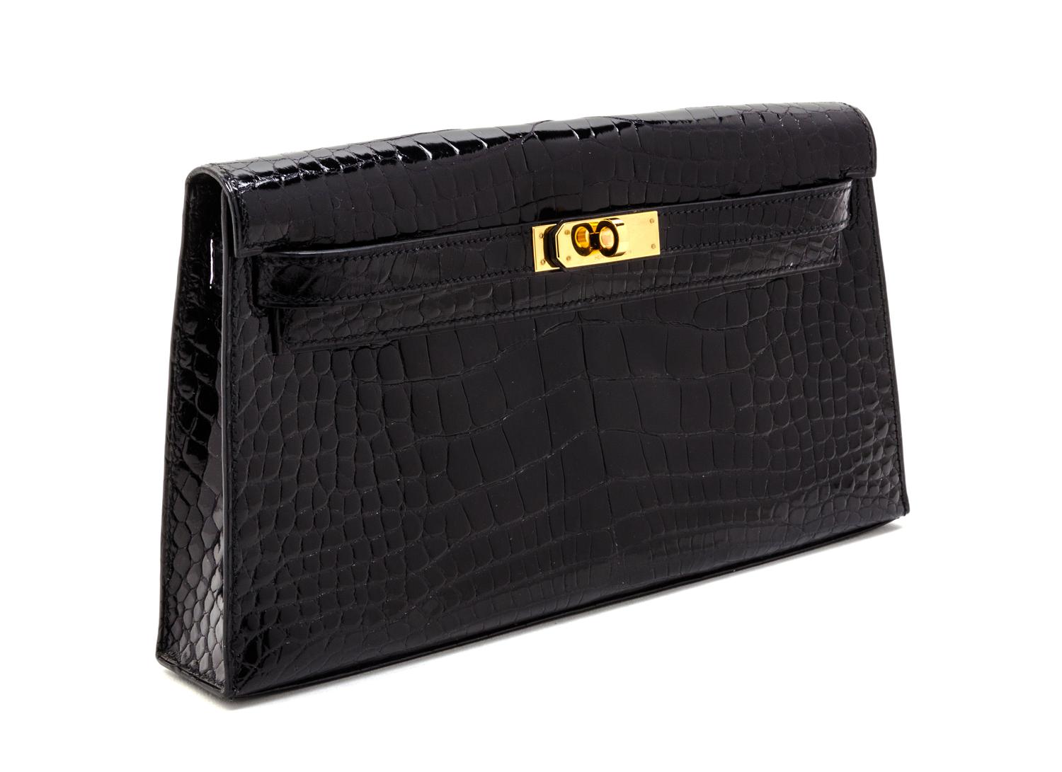 An Hermes Black Shiny Alligator Kelly Clutch Bag, 11 x 6 x 1 1/2 inches.