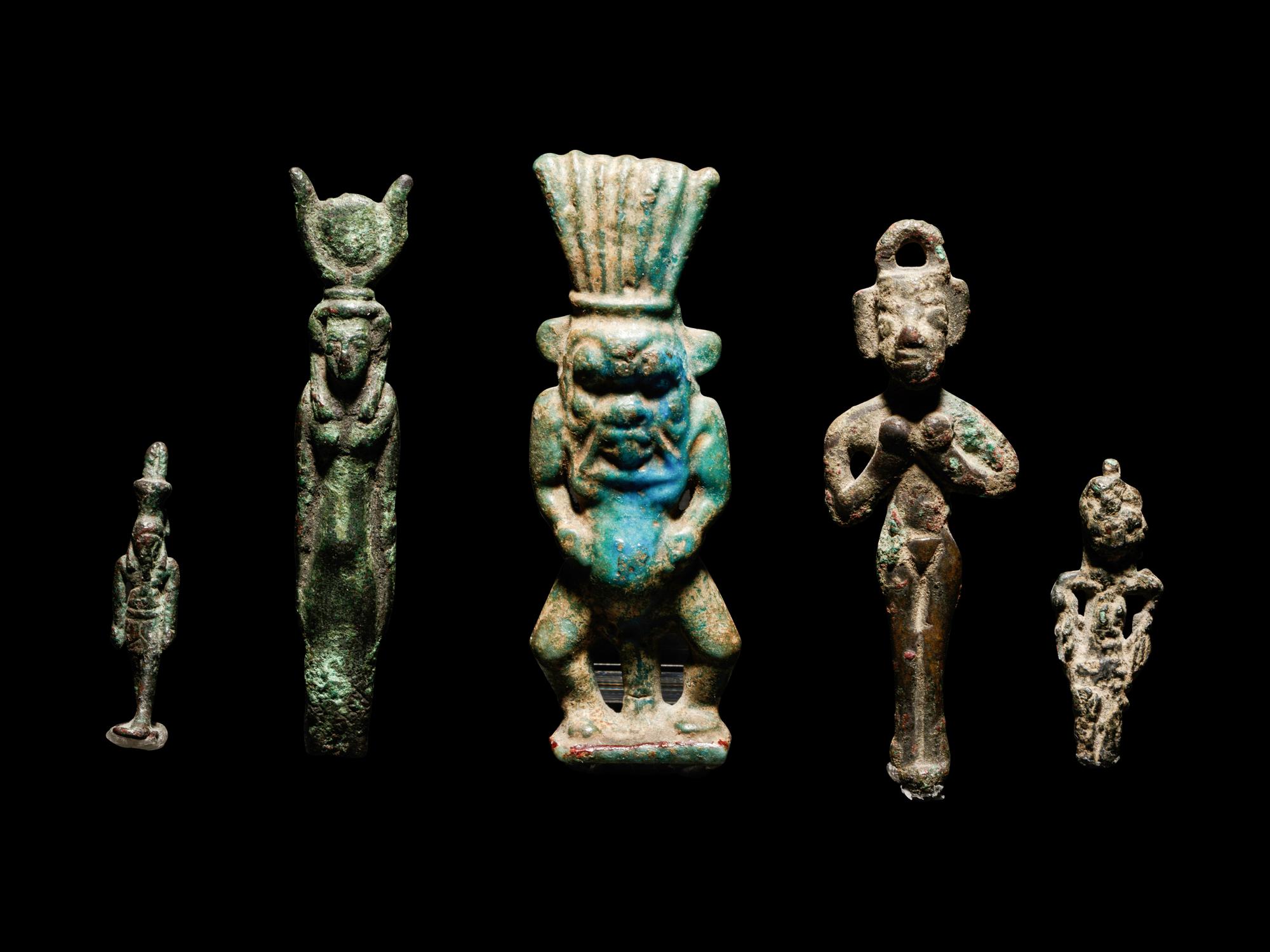 Four Egyptian Bronze Figures and One Egyptian Faience Bes
