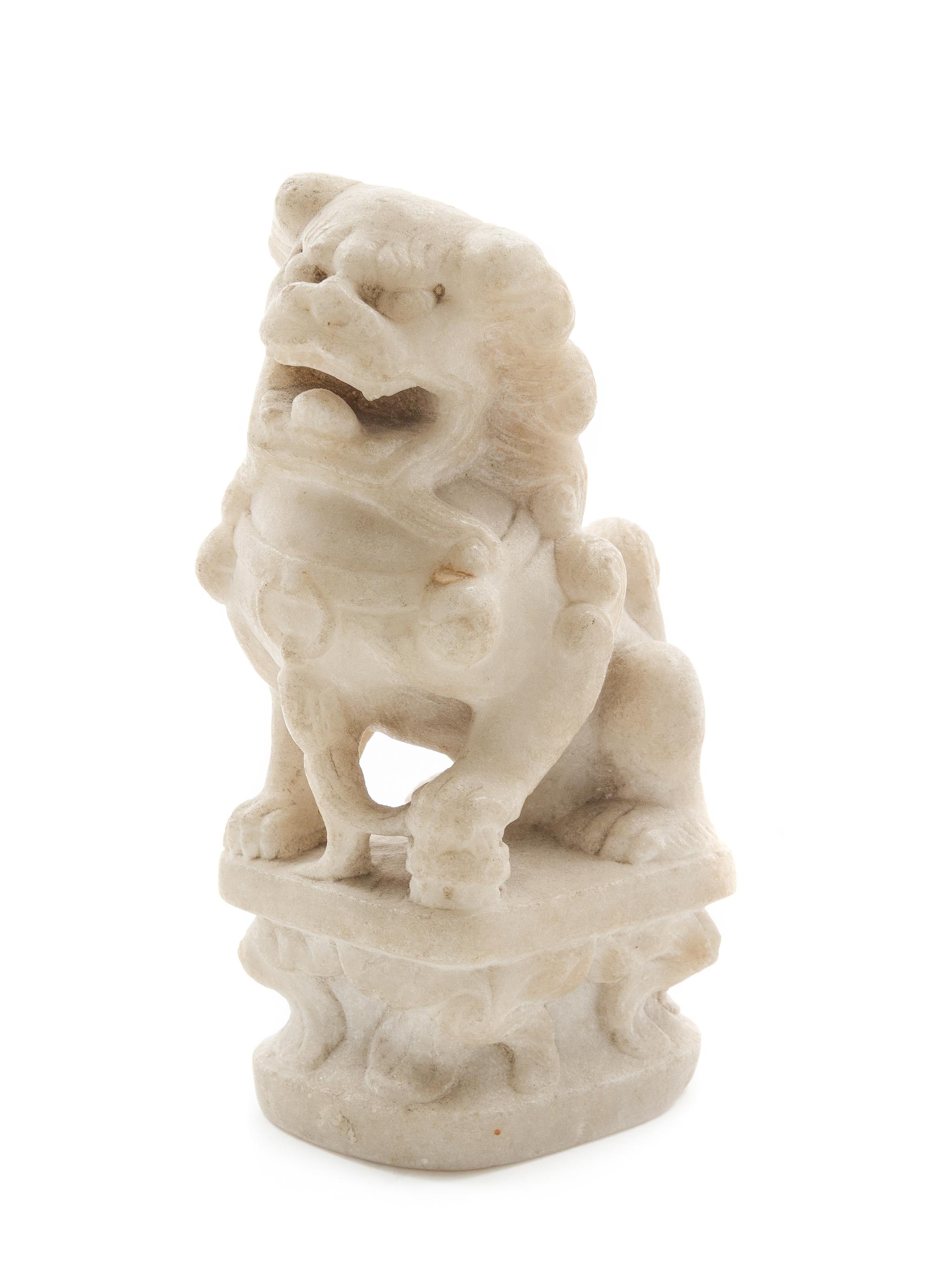 A Carved Marble Figure of a Fu Lion Height 5 1/4 x width 3 inches.