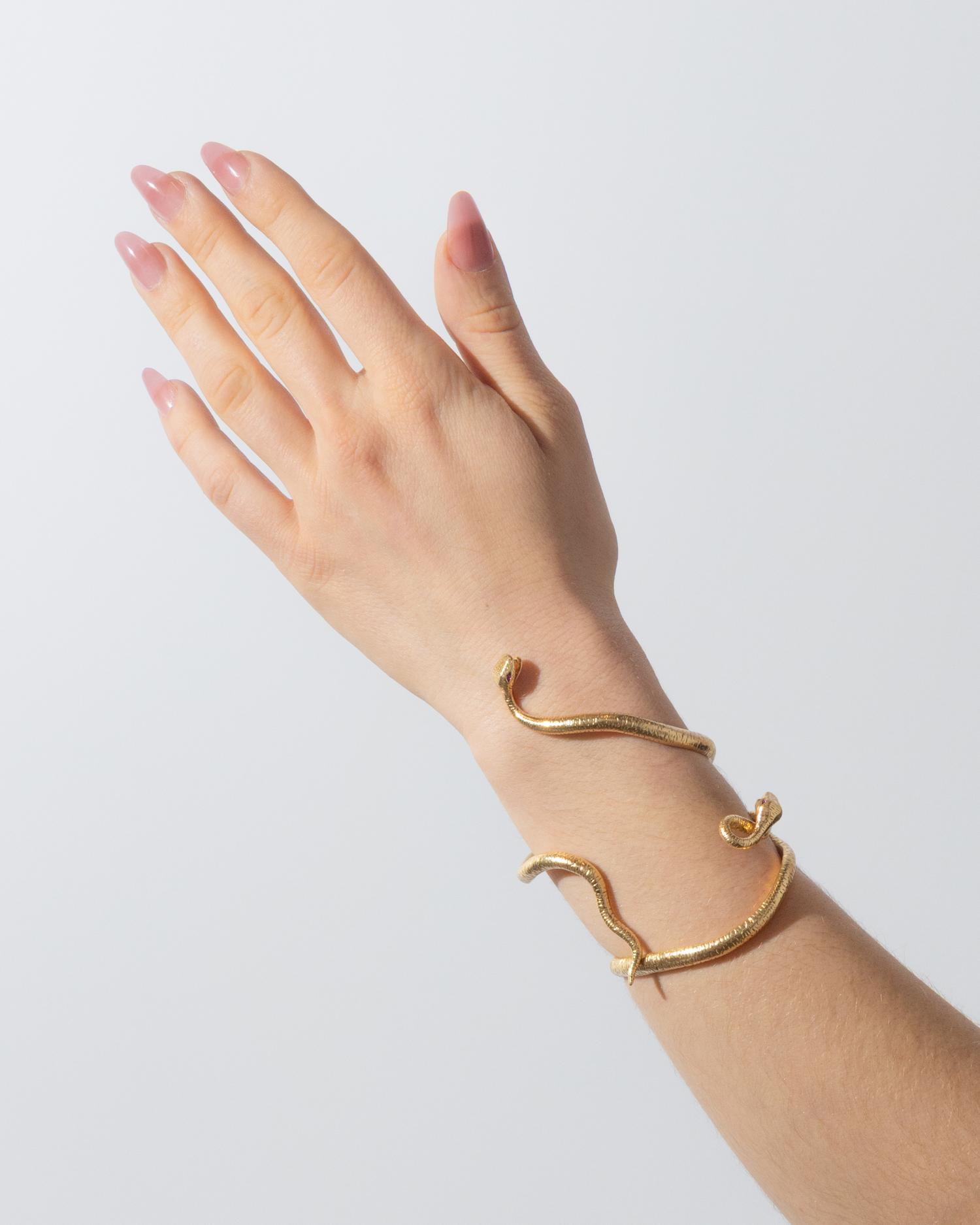 VERDURA, PAIR OF YELLOW GOLD AND RUBY 'MEDUSA' SERPENT CUFF BRACELETS