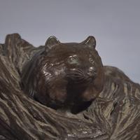 A Japanese Patinated Bronze Figure of a Tanuki in Grasses, Meiji/Taisho Period, The Maruki Co., Tokyo — 日本明治/大正時代 “丸喜製銅”銅狸貓置物