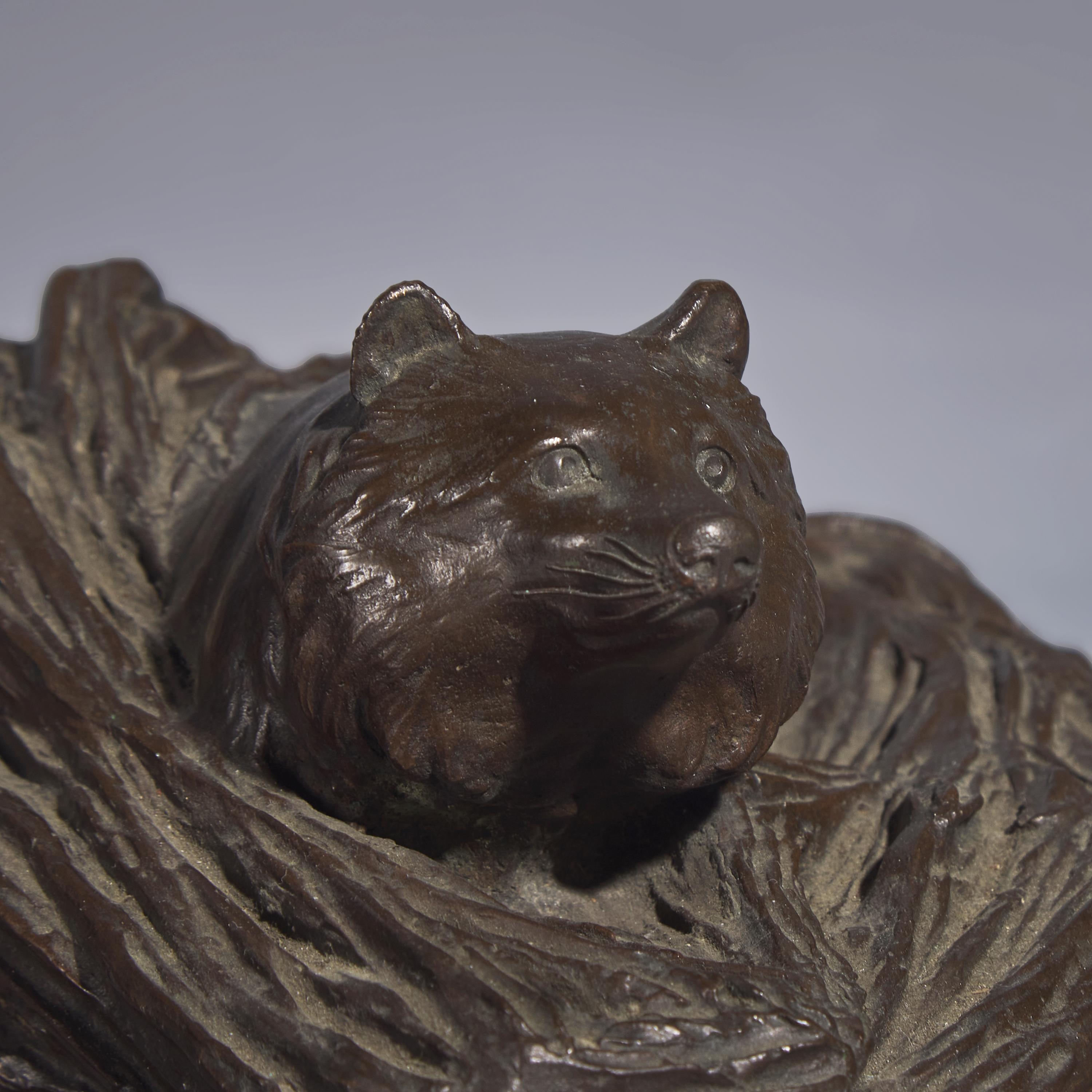 A Japanese Patinated Bronze Figure of a Tanuki in Grasses, Meiji/Taisho Period, The Maruki Co., Tokyo — 日本明治/大正時代 “丸喜製銅”銅狸貓置物