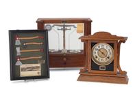 A Central Scientific Co. Scale, an Ingraham Eight-Day Movement Mantle Clock and Framed Salesmen Samples of Blue Grass Axes