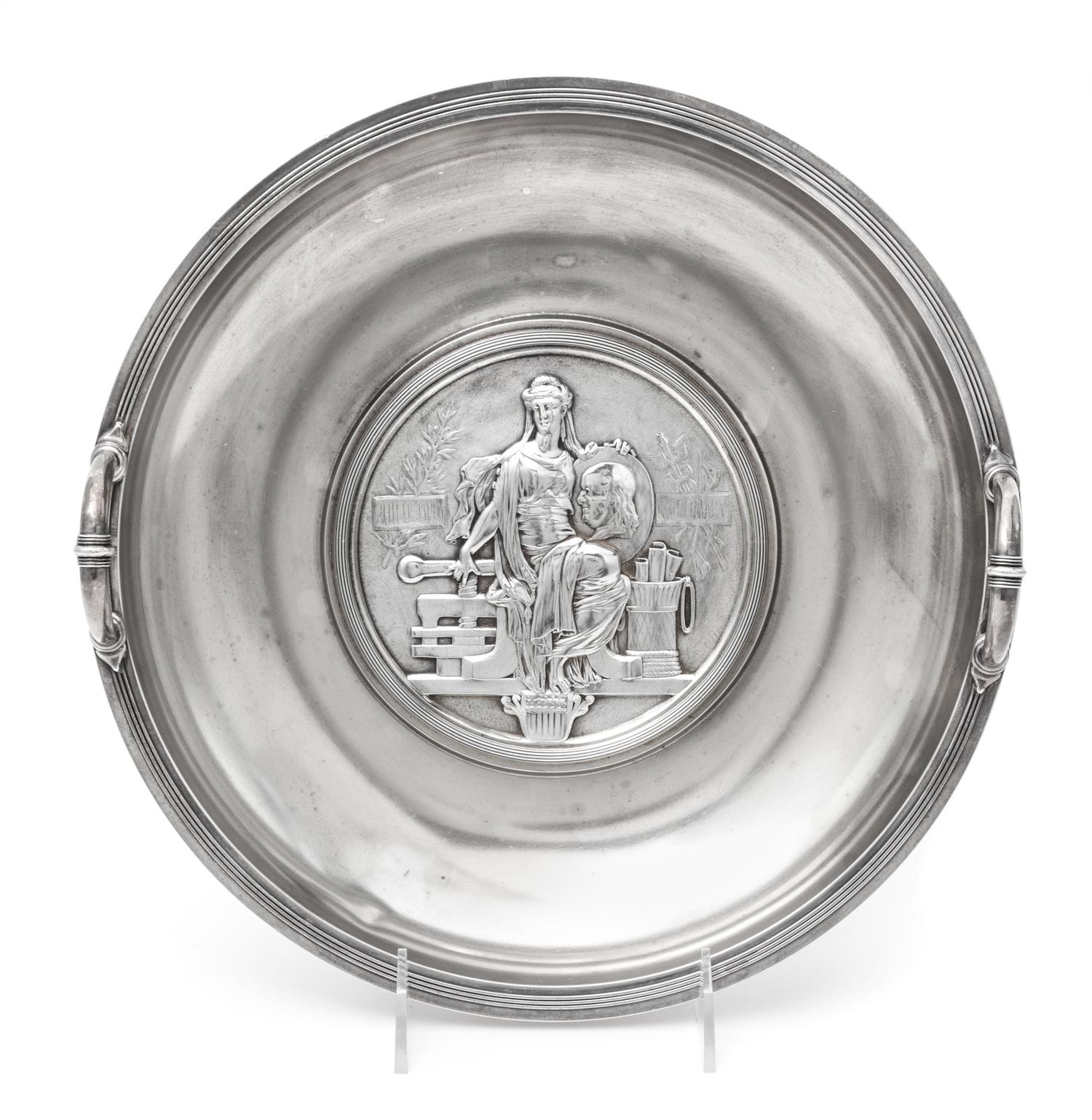An American Silver Commemorative Dish, Gorham Mfg. Co., Providence, RI, 1876, the twin-handled circular dish centered with a medallion