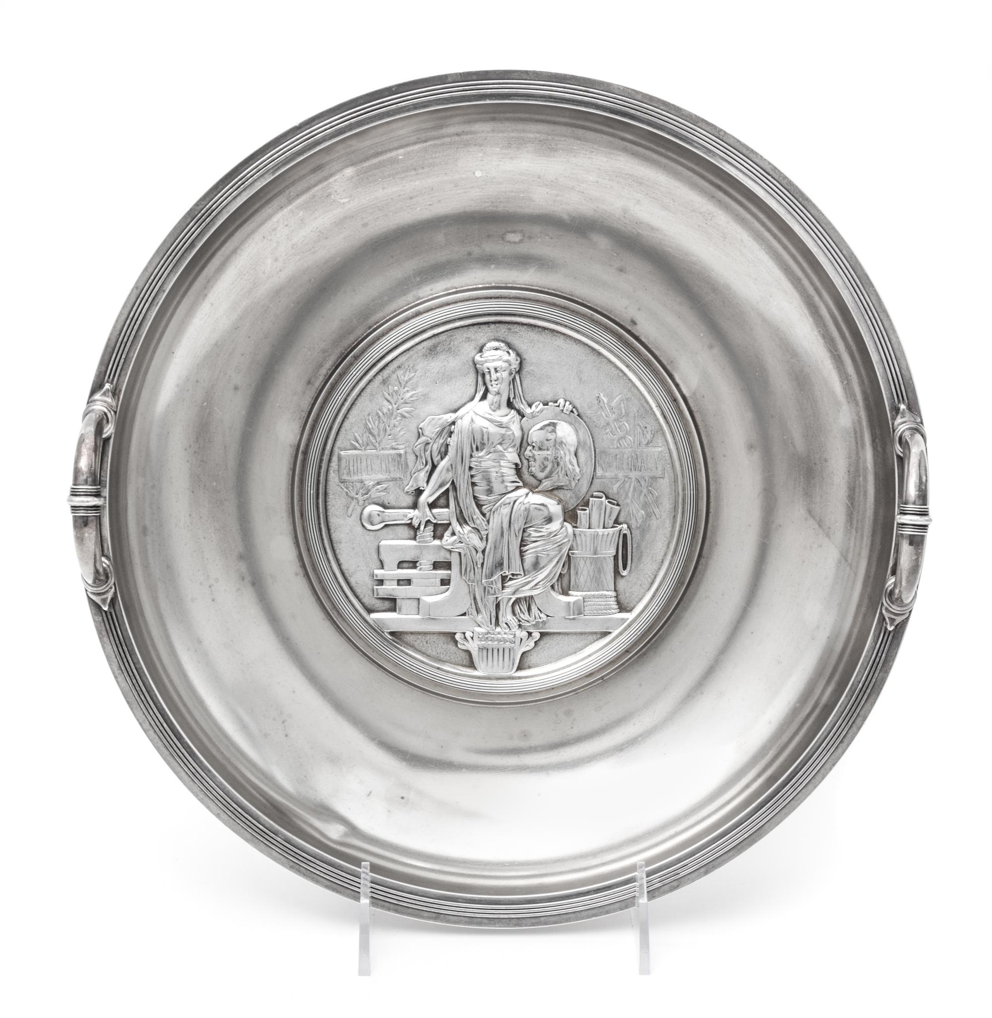An American Silver Commemorative Dish, Gorham Mfg. Co., Providence, RI, 1876, the twin-handled circular dish centered with a medallion