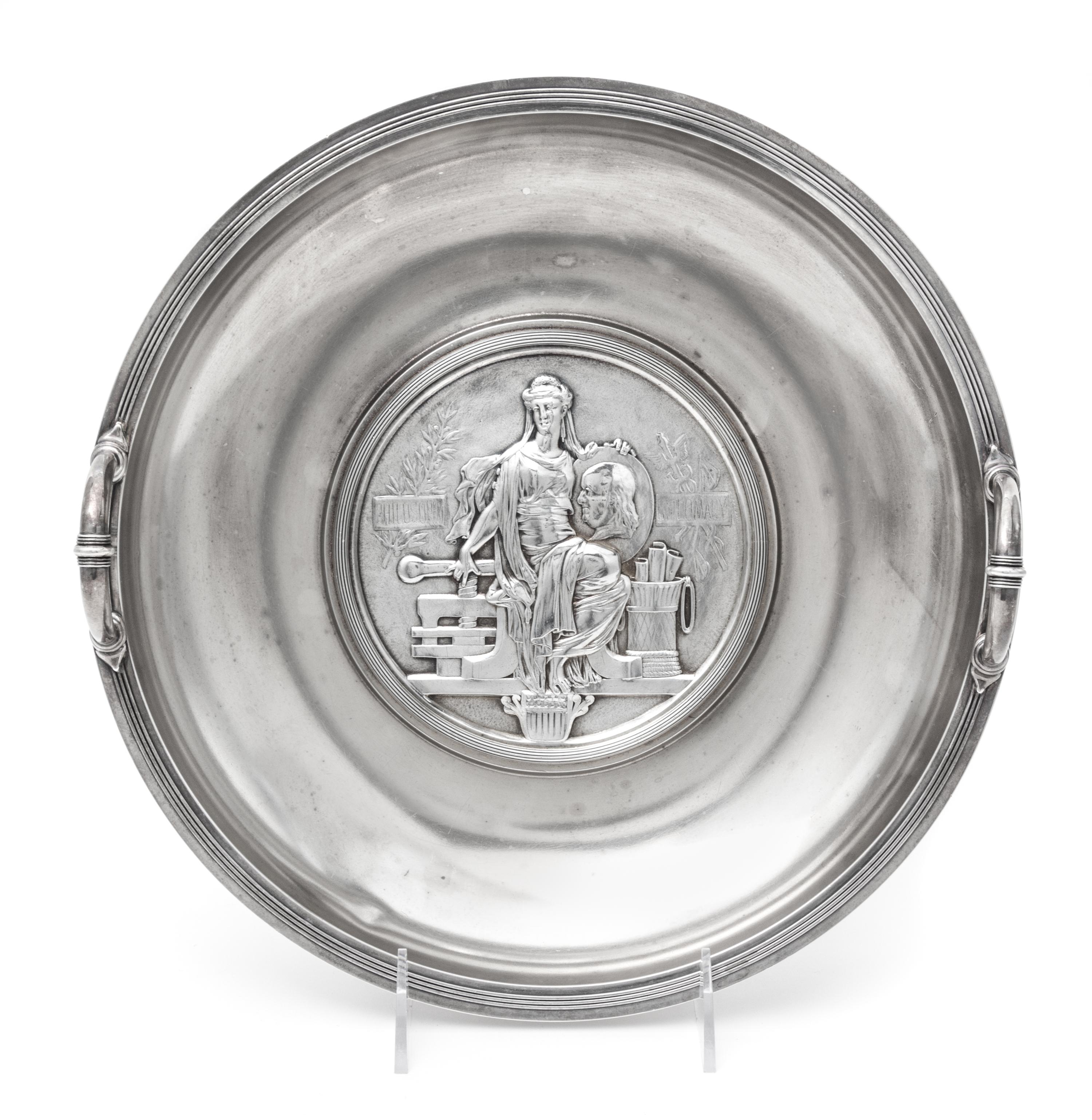 An American Silver Commemorative Dish, Gorham Mfg. Co., Providence, RI, 1876, the twin-handled circular dish centered with a medallion