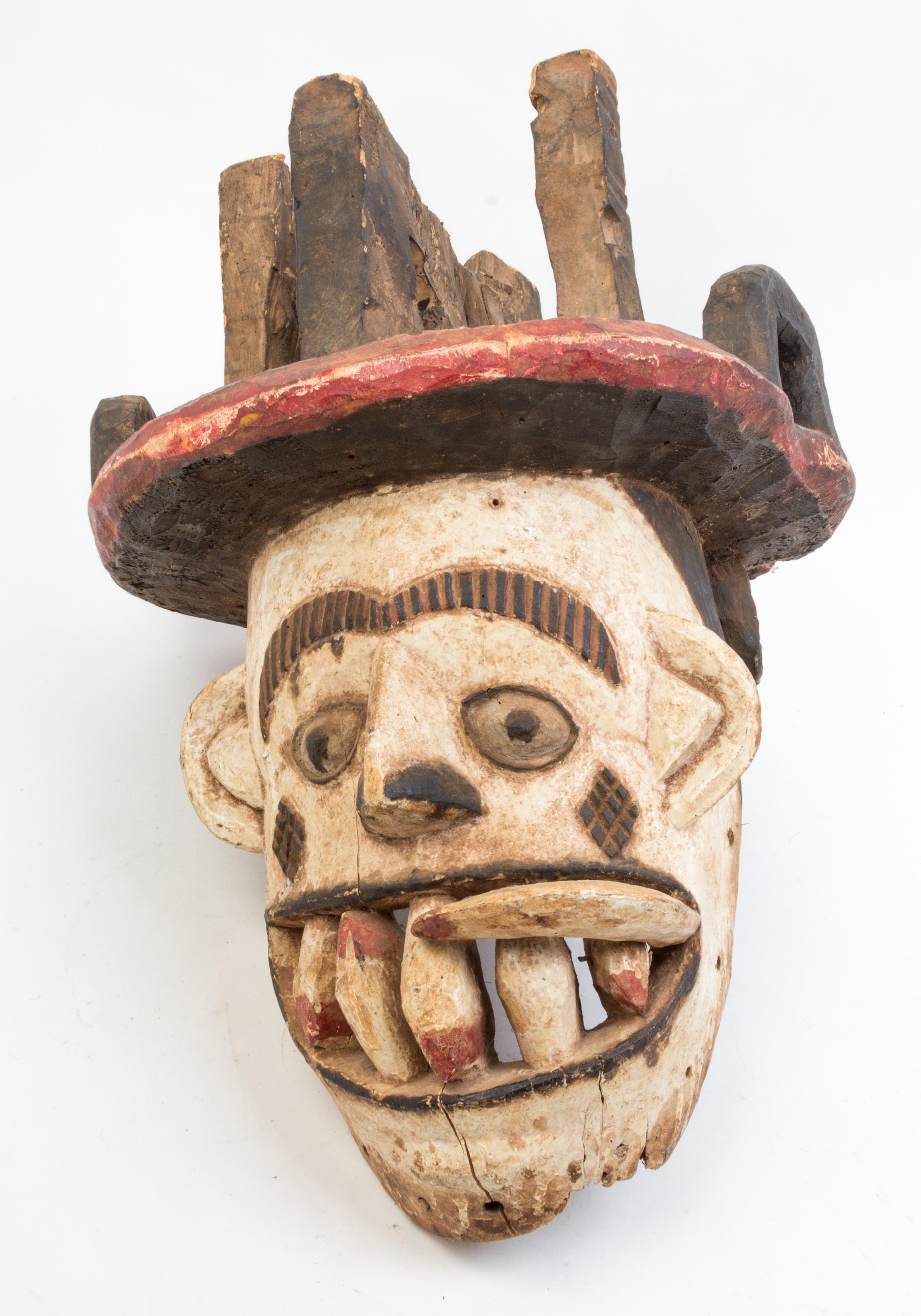 A Group of Four Masks Height of largest 23 inches.