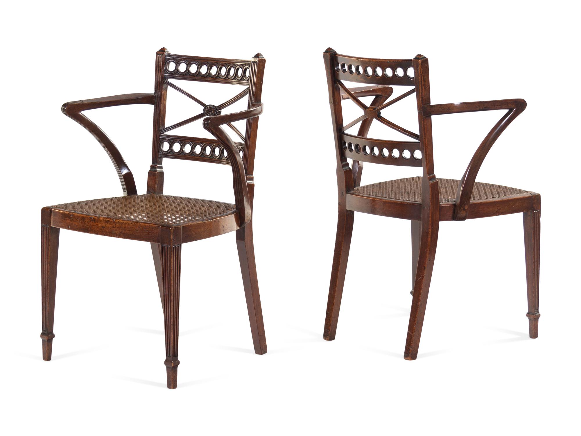 A Pair of Regency Carved Mahogany Cane Upholstered Armchairs