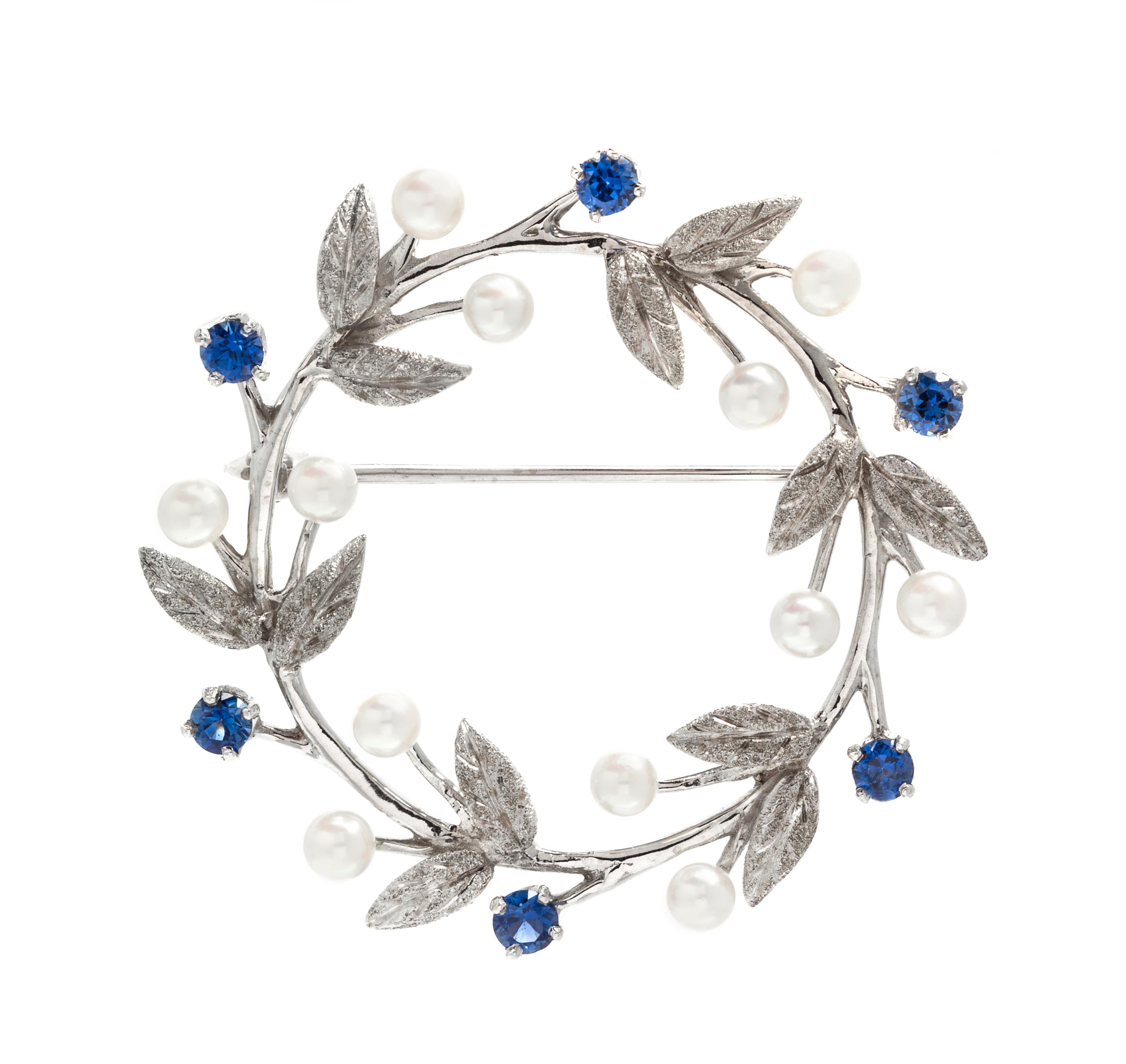 A 14 Karat White Gold, Sapphire and Cultured Pearl Wreath Brooch, 6.20 dwts.