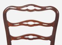 A set of eight Chippendale style mahogany ribbon-back dining chairs, 20th century