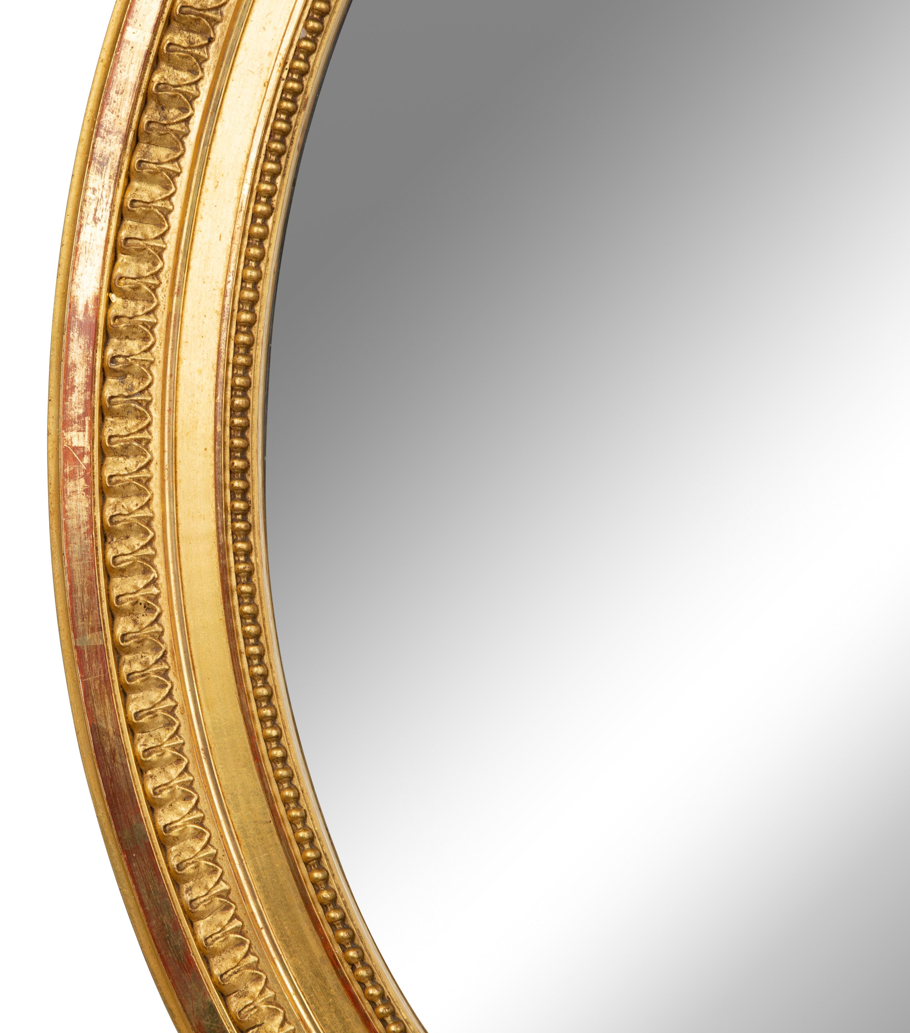 A Louis XV Style Giltwood Framed Oval Mirror