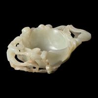 A Chinese Carved Pale Celadon Jade Floriform Coupe, Qing Dynasty or Earlier 清或更早 青白玉鏤雕梅花洗