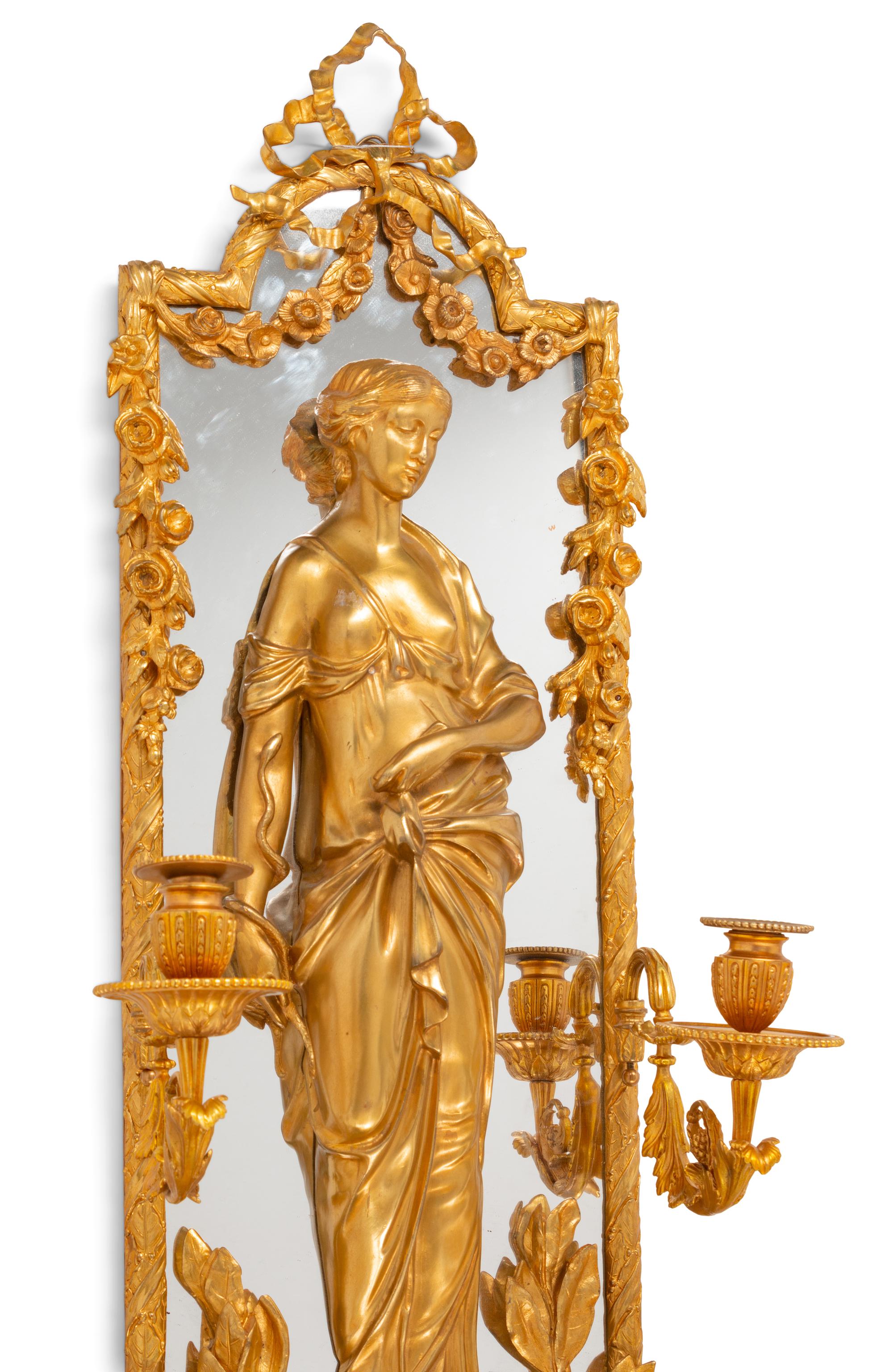 A Pair of Large Louis XVI Style Mirrored Gilt Bronze Figural Sconces