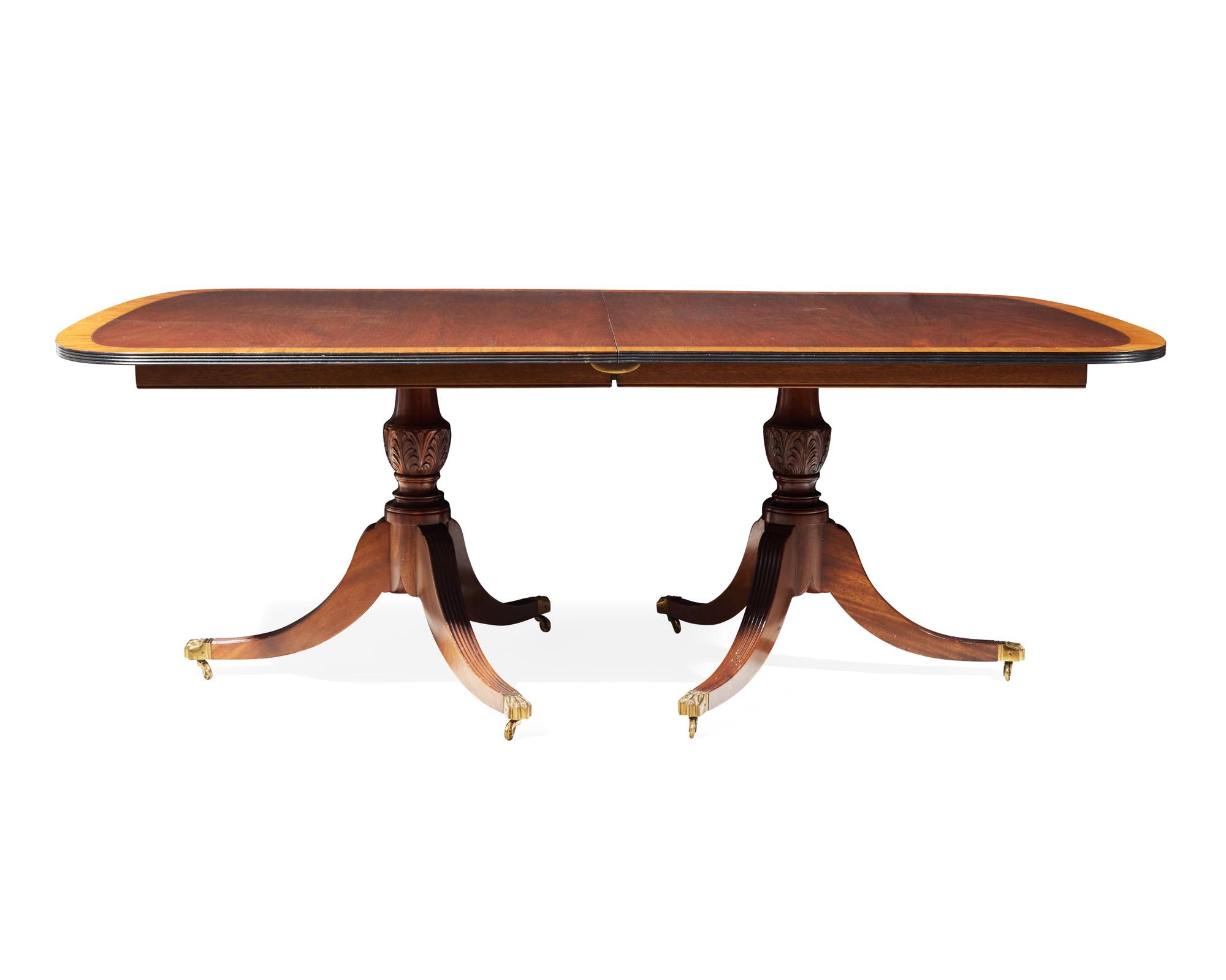 A Regency style two-pedestal inlaid mahogany and satinwood dining table, 20th century