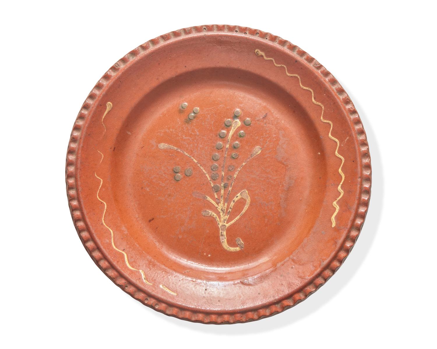 A Glazed and Slip-Decorated Redware Plate, Continental, 19th Century