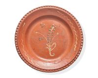A Glazed and Slip-Decorated Redware Plate, Continental, 19th Century