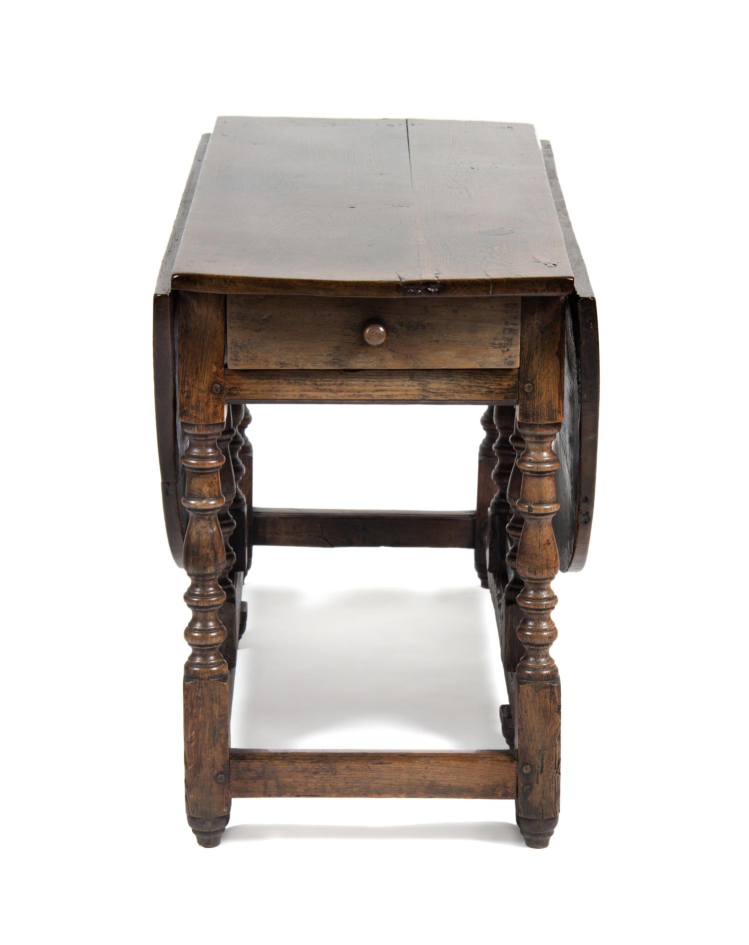 An English Oak Gate Leg Table Height 29 1/2 x width 52 x depth 21 inches (closed).