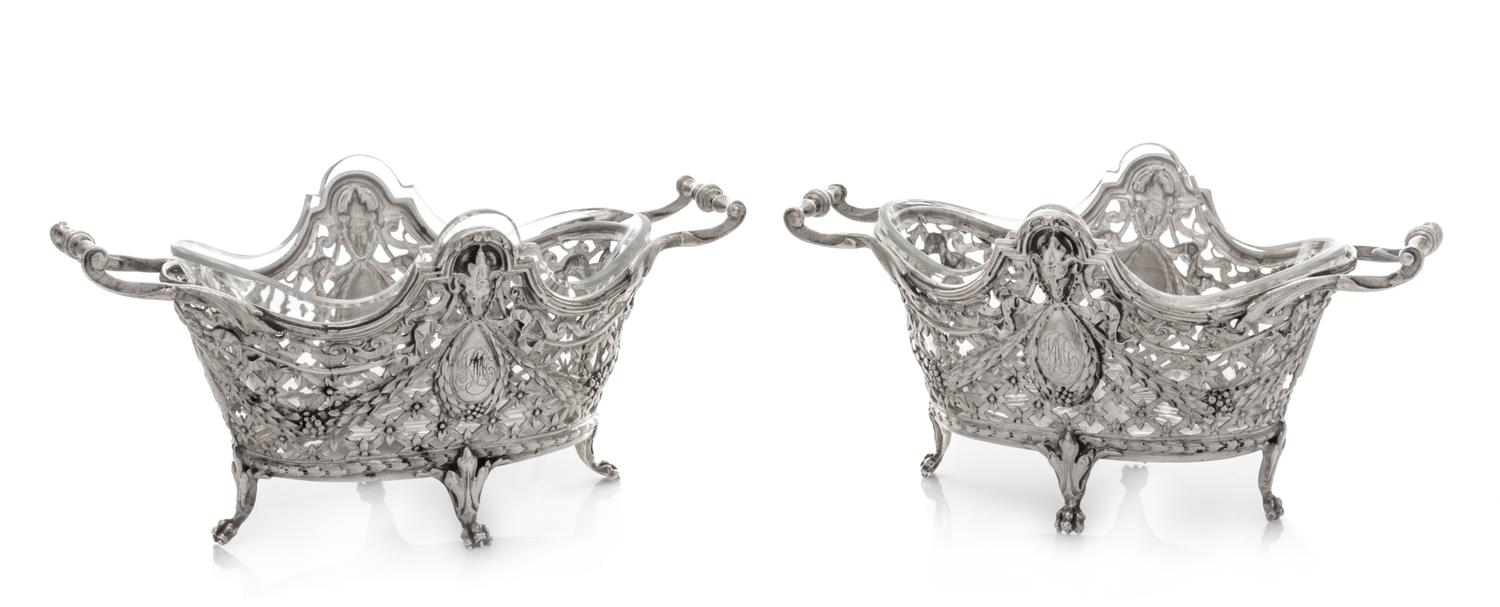 A Pair of Continental Silver Bonbon Dishes, , each rim decorated with ram masks above an openwork body formed of floral and foliate fes