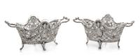 A Pair of Continental Silver Bonbon Dishes, , each rim decorated with ram masks above an openwork body formed of floral and foliate fes