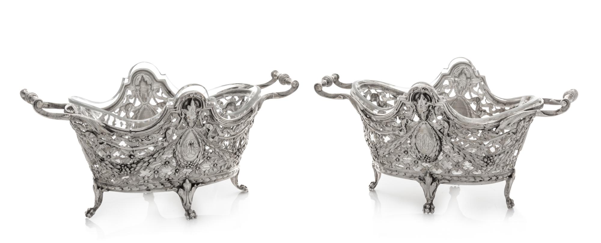A Pair of Continental Silver Bonbon Dishes, , each rim decorated with ram masks above an openwork body formed of floral and foliate fes
