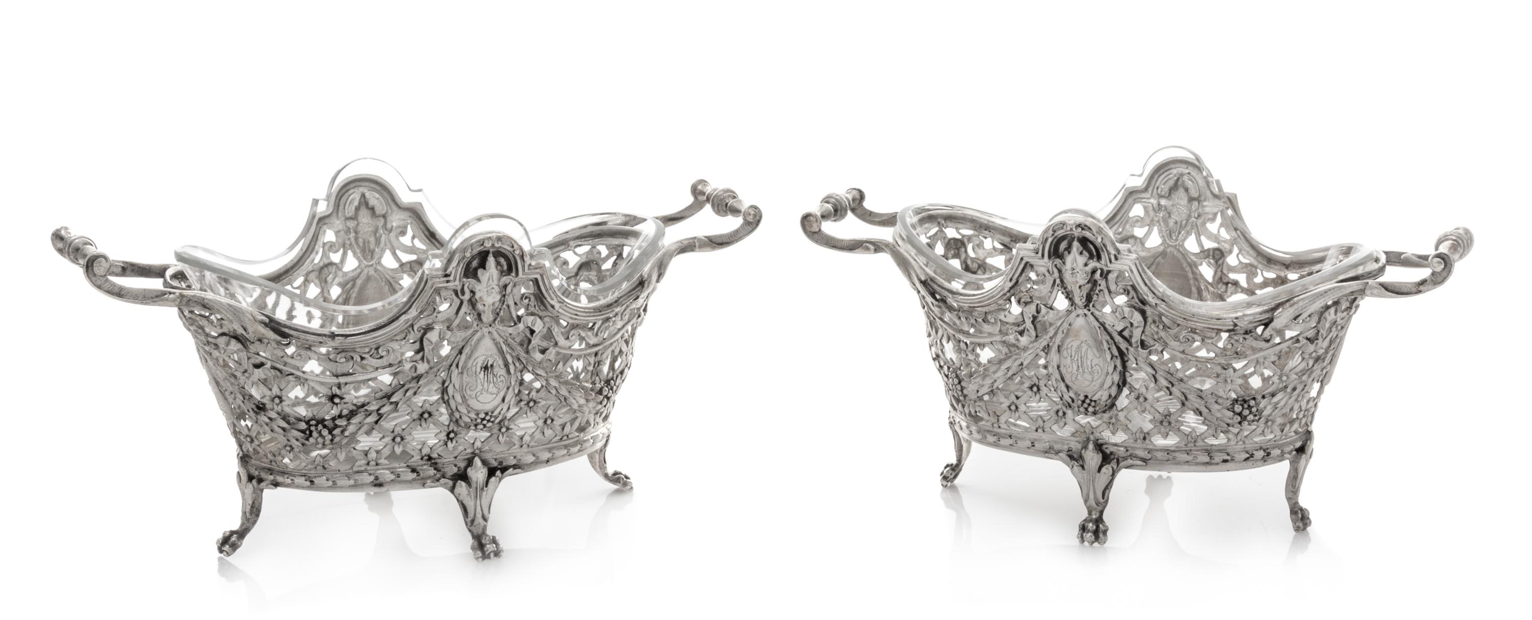 A Pair of Continental Silver Bonbon Dishes, , each rim decorated with ram masks above an openwork body formed of floral and foliate fes