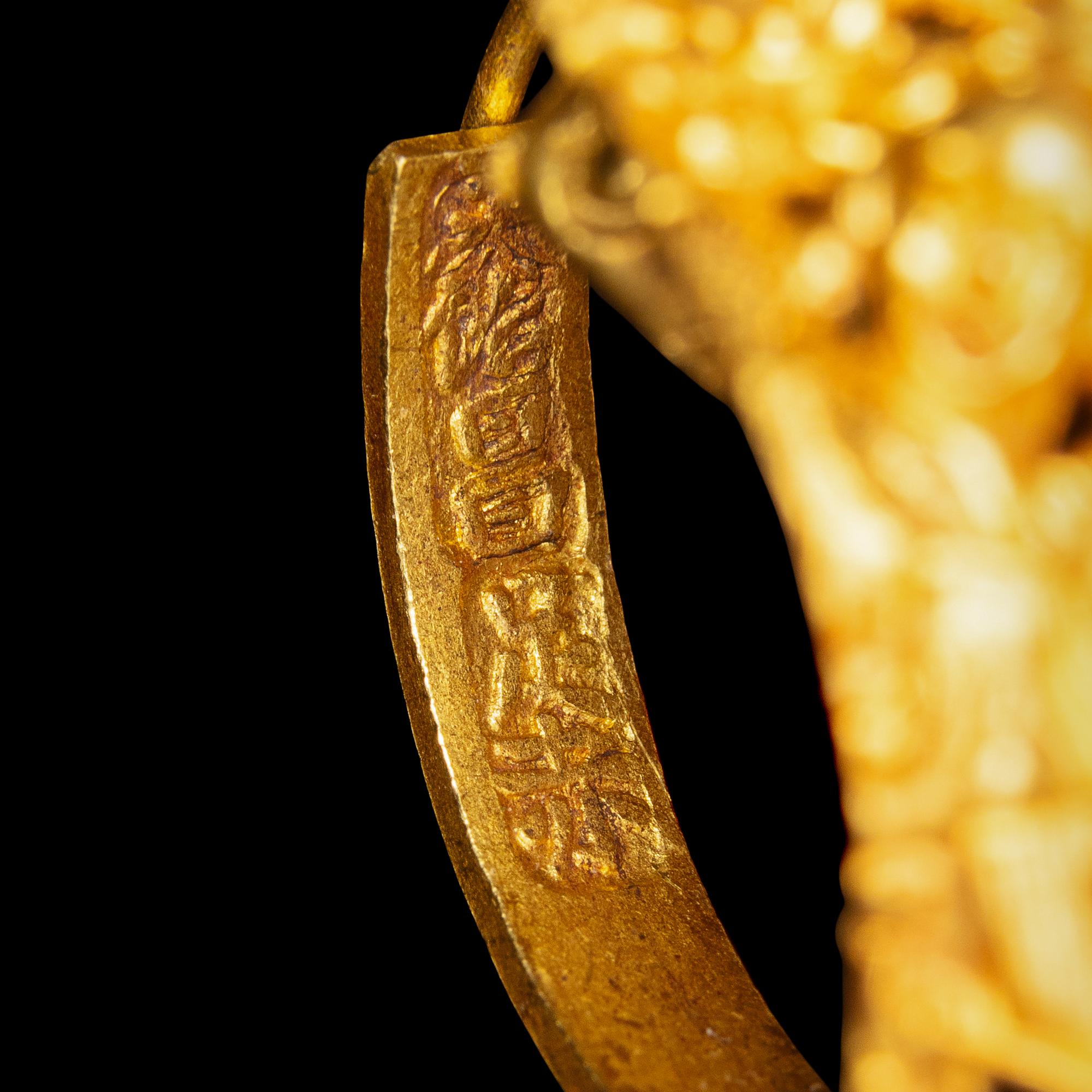 A Pair of Chinese Gold 'Figural and Fruits' Plaque Earrings, Paihuan, Qing Dynasty 清 童子瓜果紋 金 牌環一對