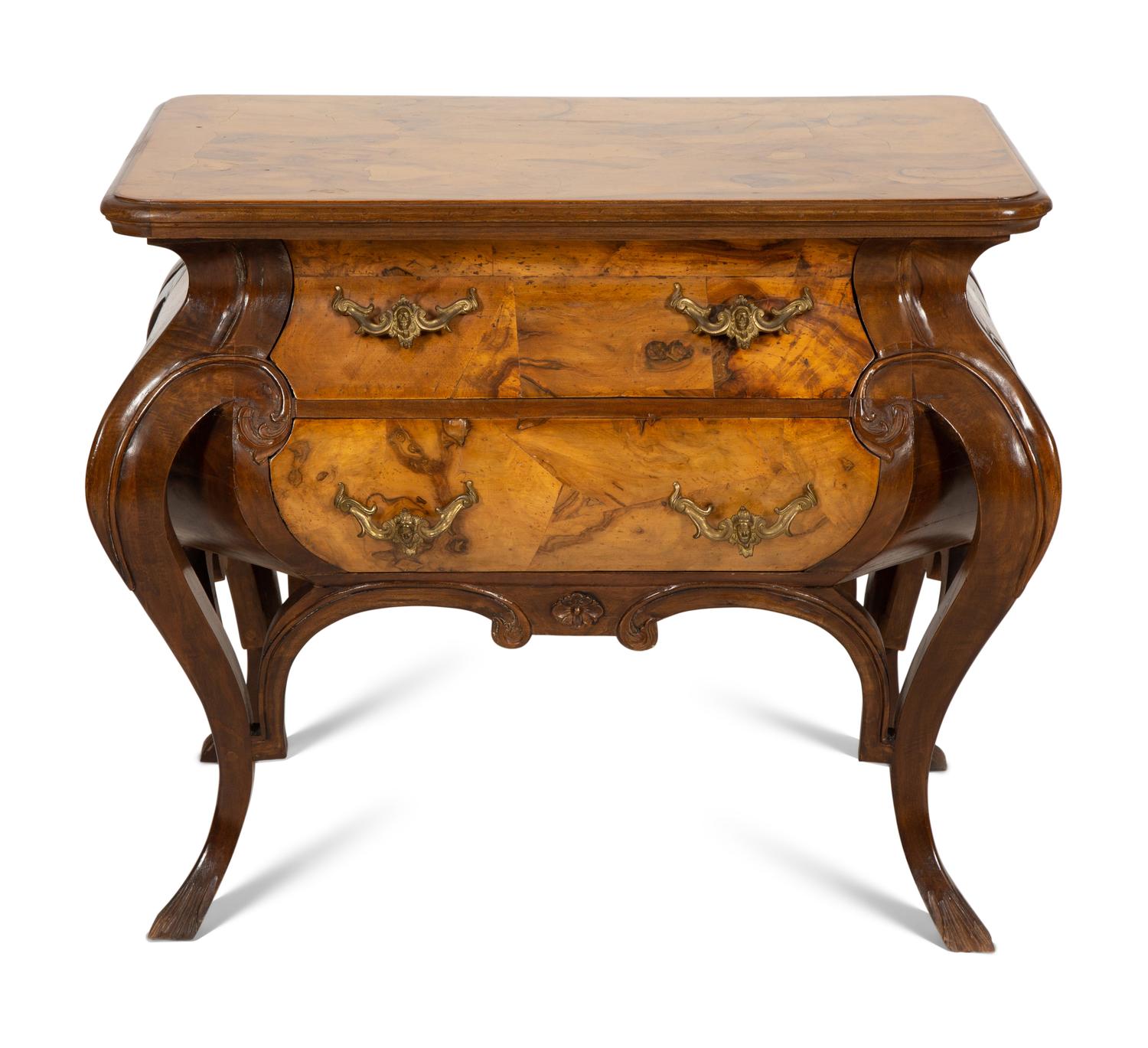 A Continental Gilt Metal Mounted Olivewood and Mahogany Bombé Commode