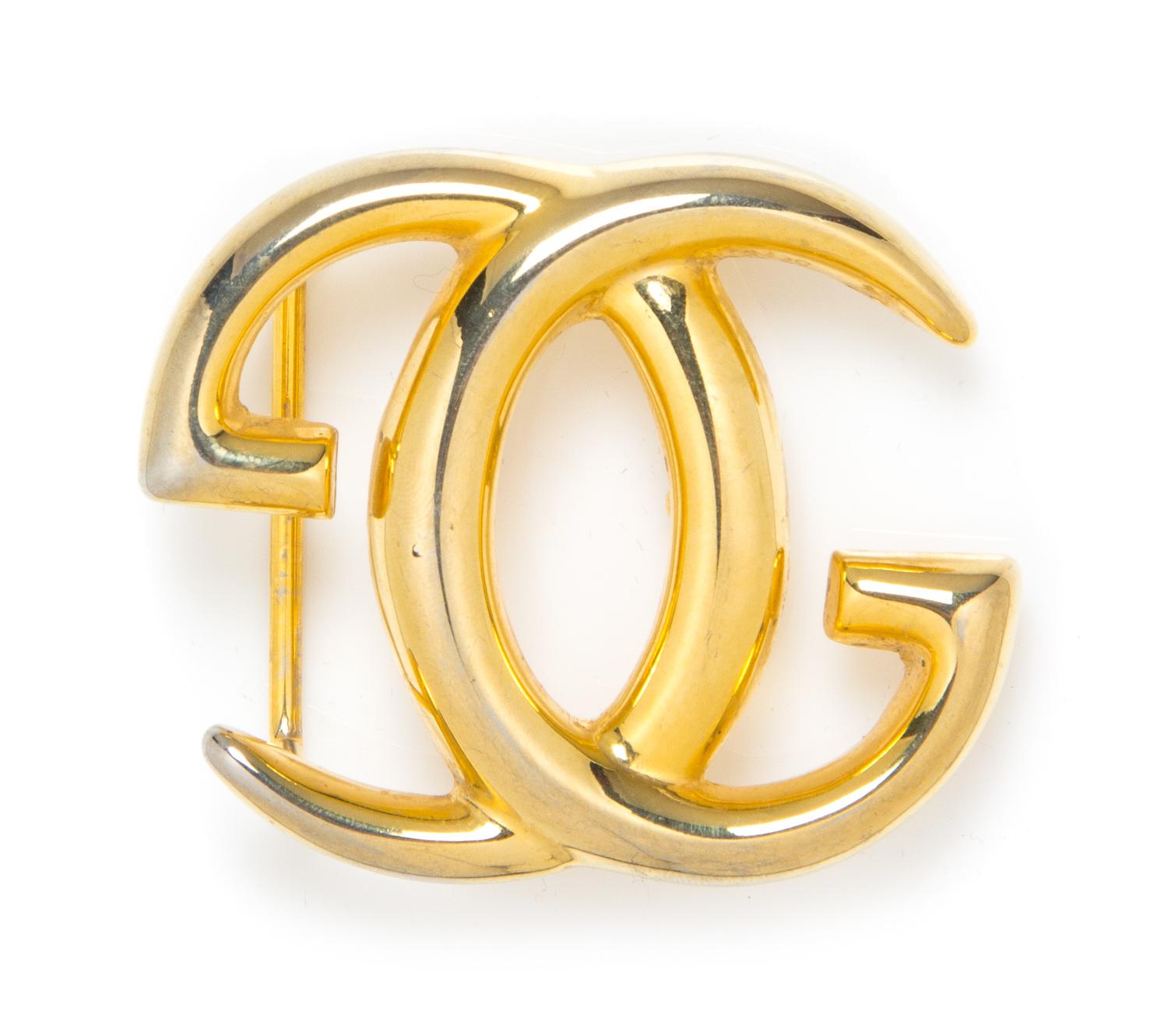 A Gucci Goldtone Logo Belt Buckle, 3" x 2.5".