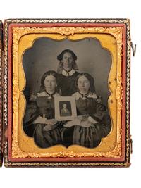 [LINCOLNIANA - EARLY PHOTOGRAPHY]. Sixth plate ambrotype of three patriotic women proudly displaying a portrait of Abraham Lincoln.